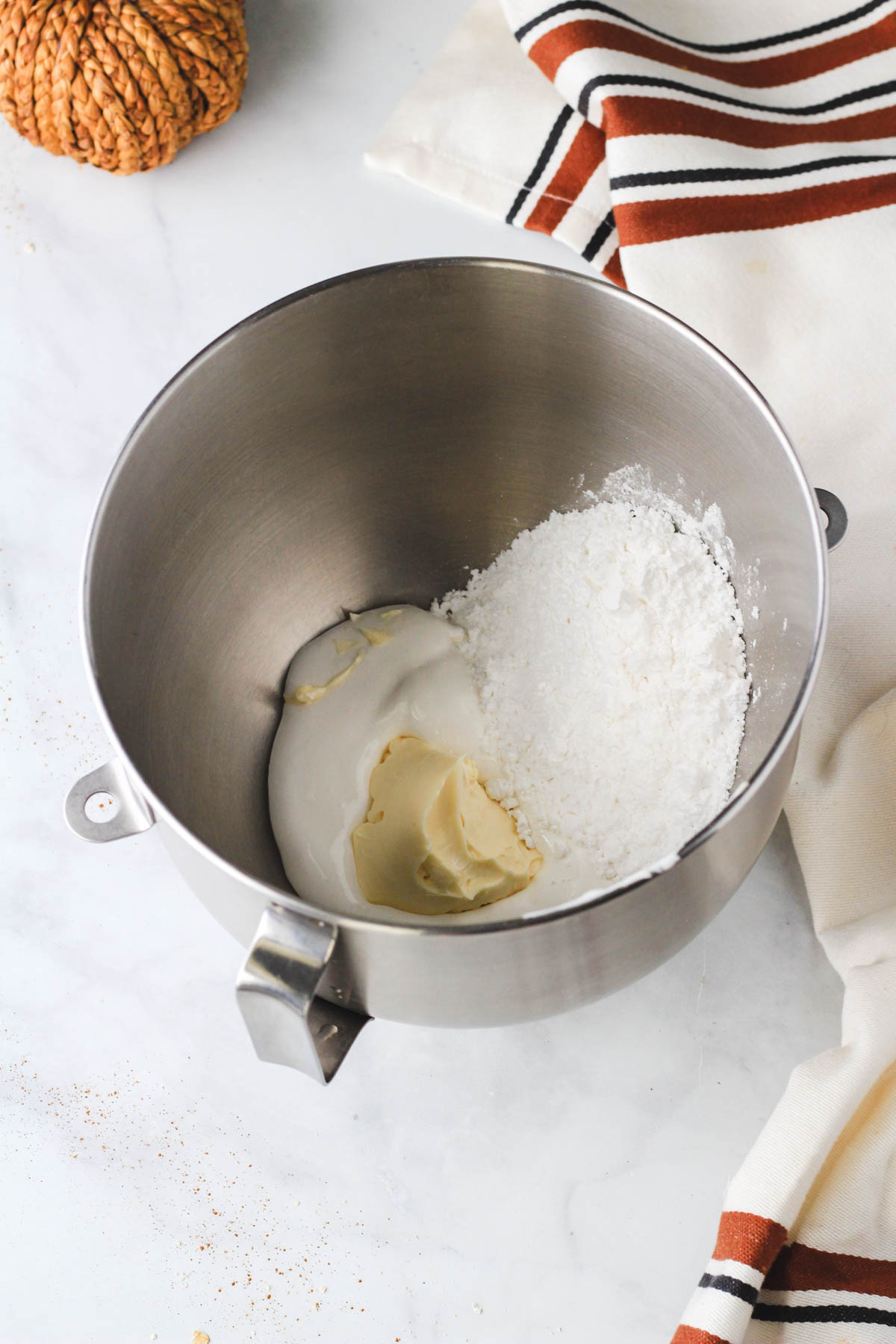 A silver mixing bowl with the ingredients for dairy-free marshmallow fluff frosting before mixing.