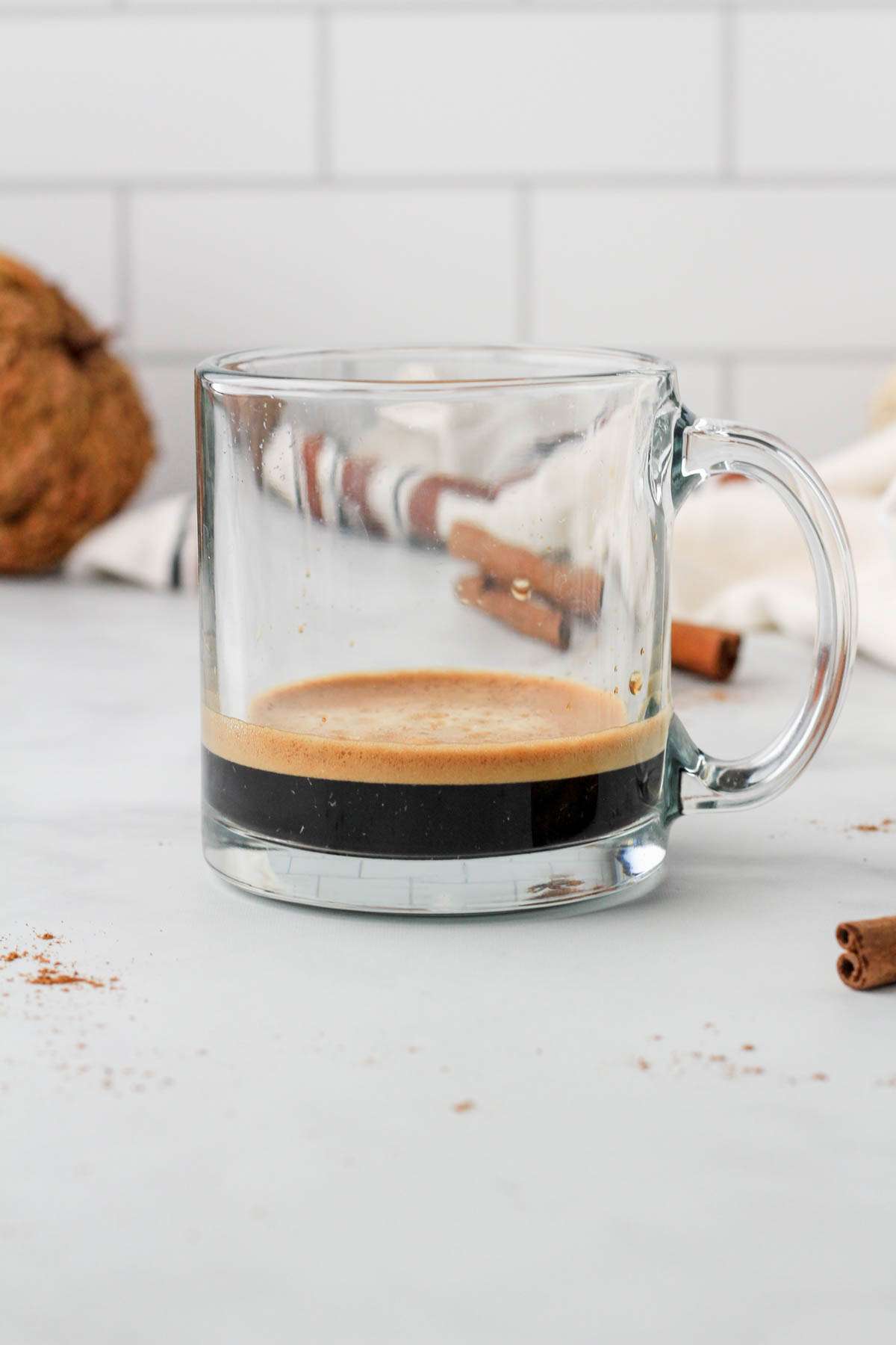 A glass coffee cup with a double shot of espresso.