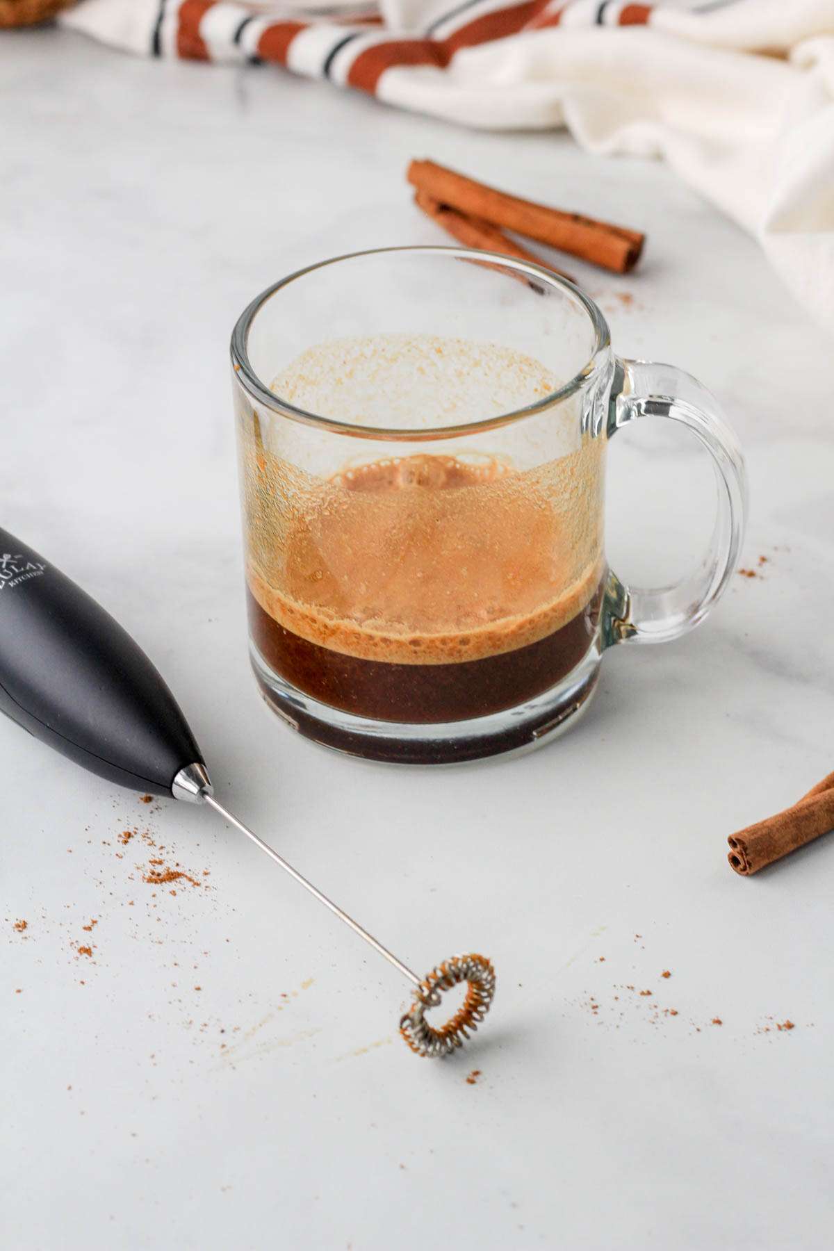 All of the ingredients for a pumpkin spice latte without the oat milk after blending.