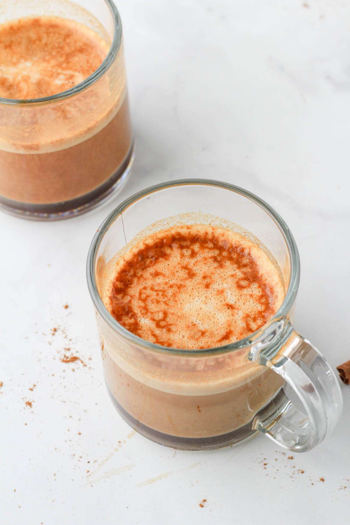 A top down picture of a pumpkin spice latte after the oat milk is poured in.