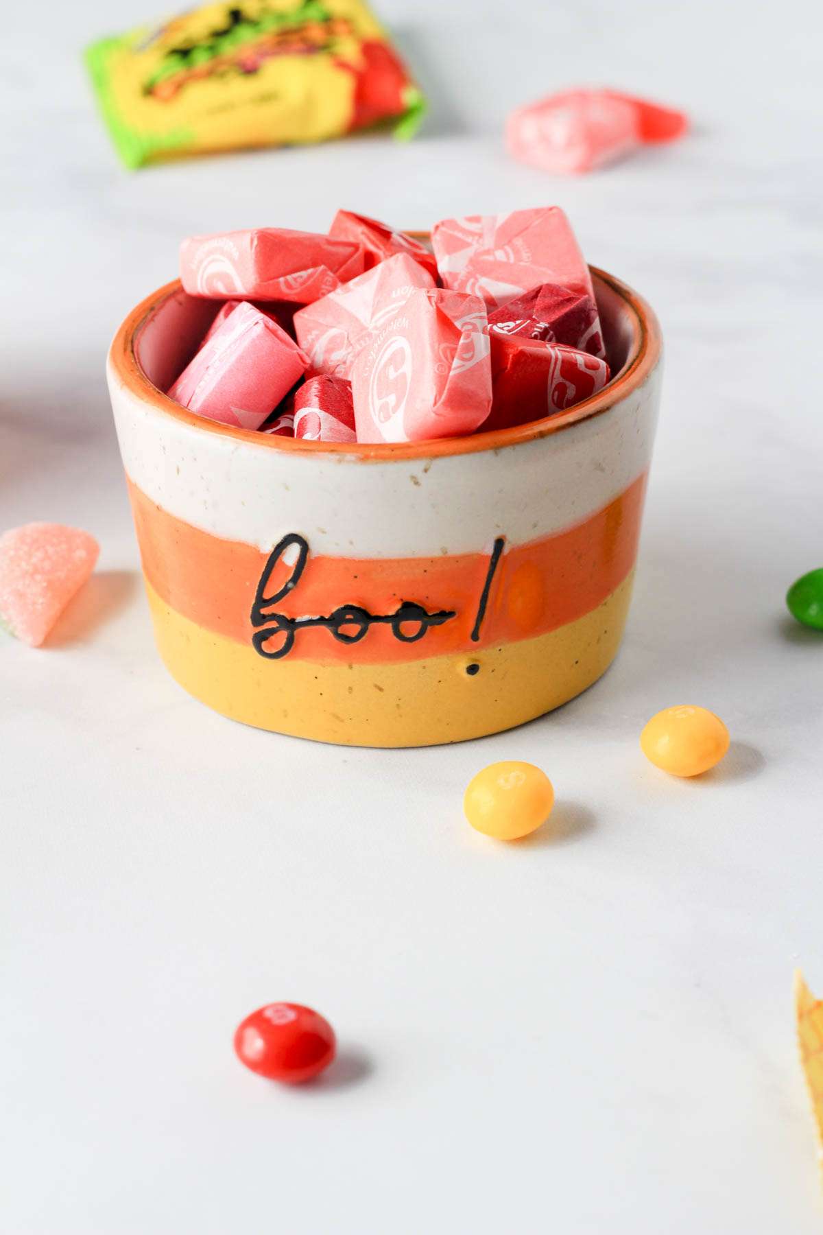 A candy corn colored bowl with starburst inside.