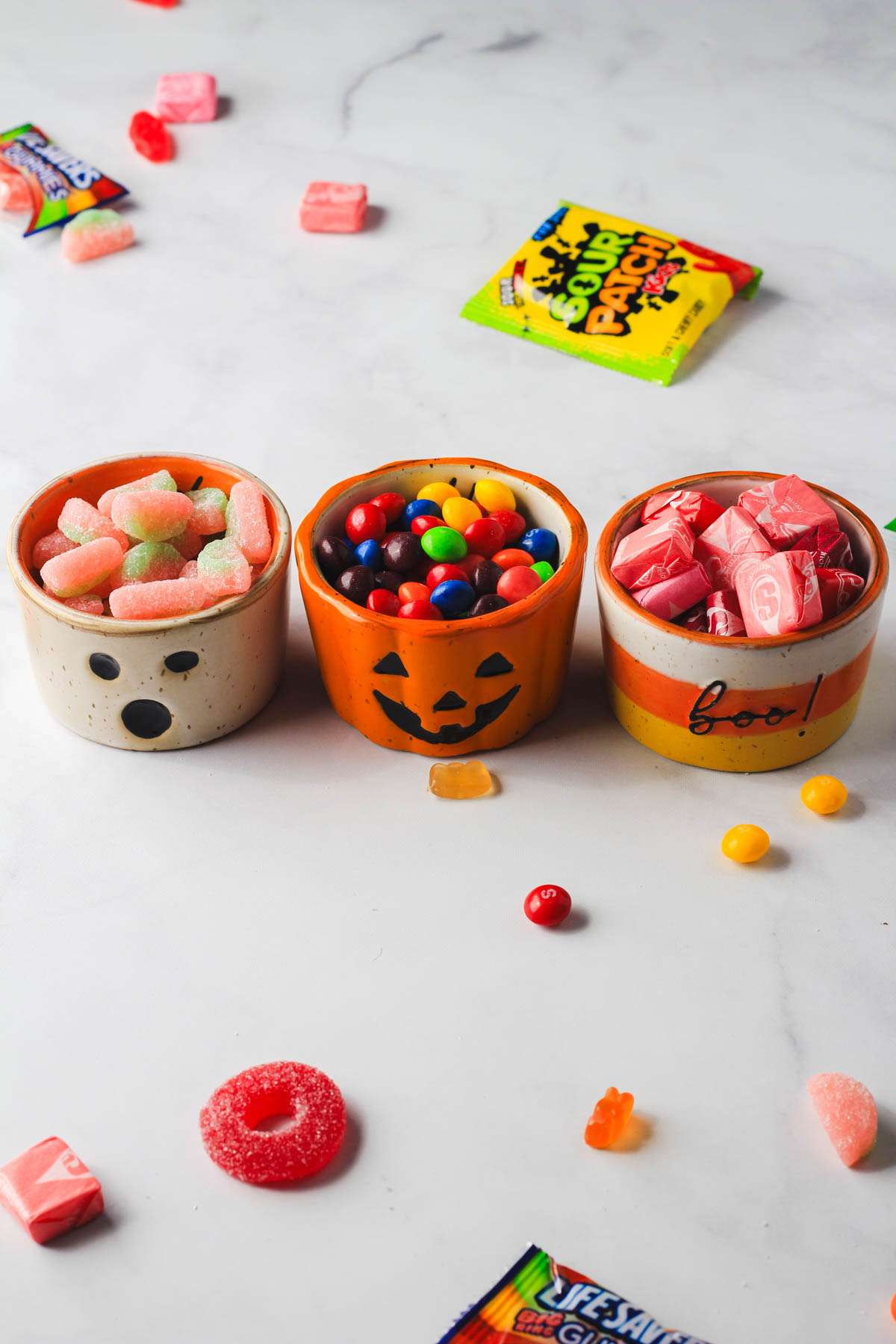 Three Halloween cups filled with dairy-free candy.
