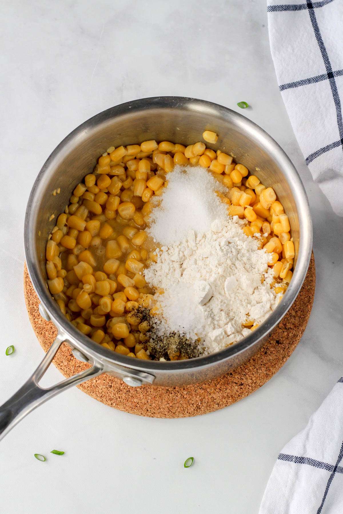 Dry ingredients on top of the corn in a sauce pan on a cork trivet.
