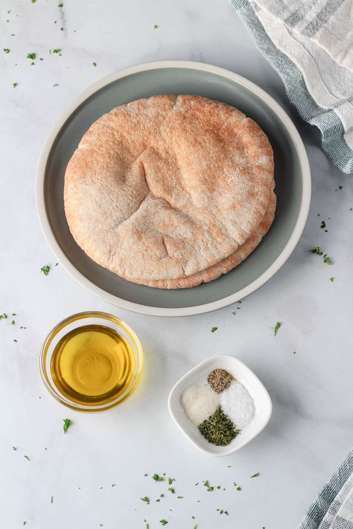 Ingredients for air fryer pita chips on a white counter.