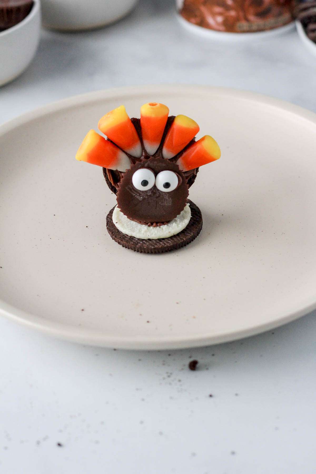 A white plate with an assembled dairy-free Oreo turkey cookie.