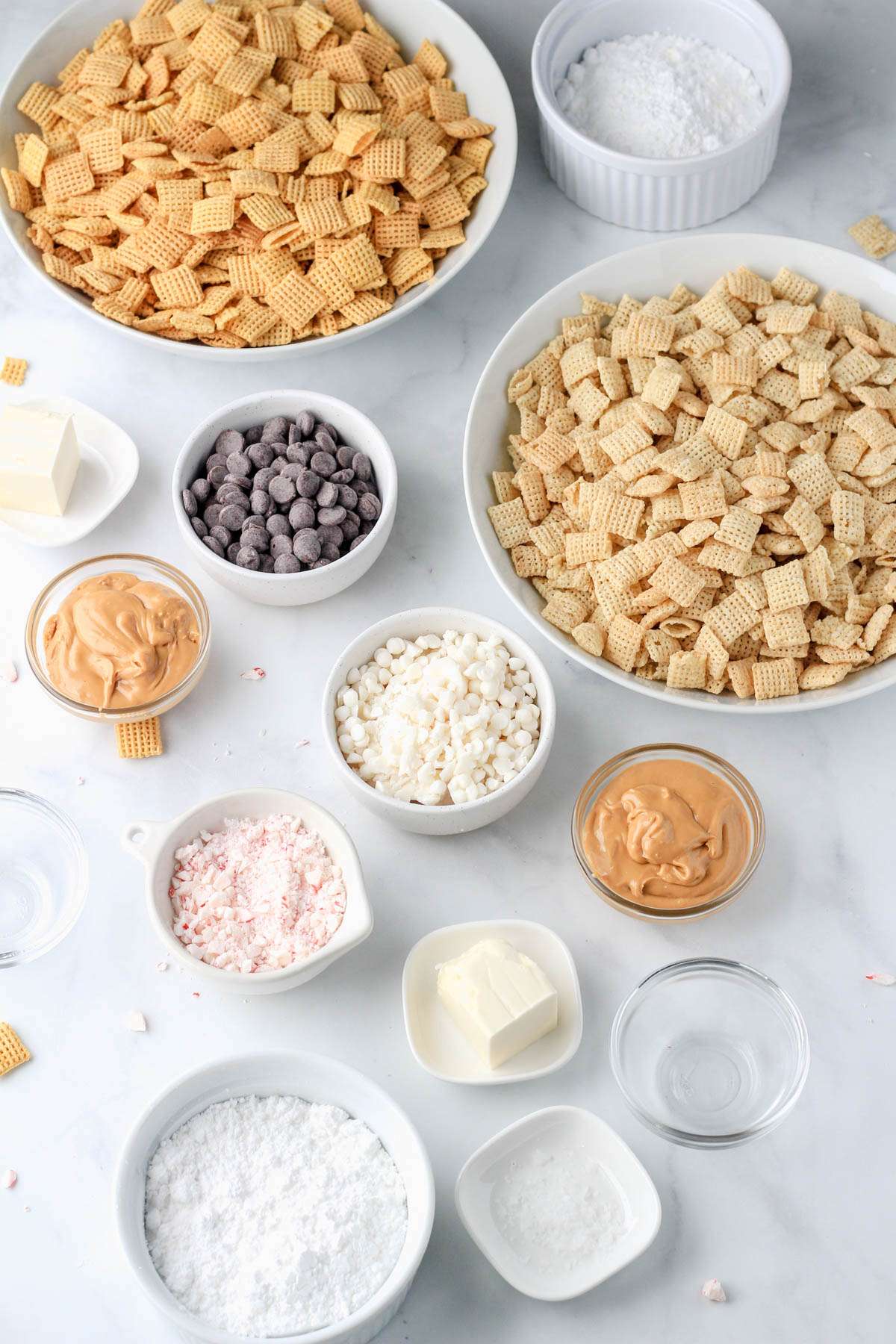Ingredients for peppermint bark puppy chow on a white counter.