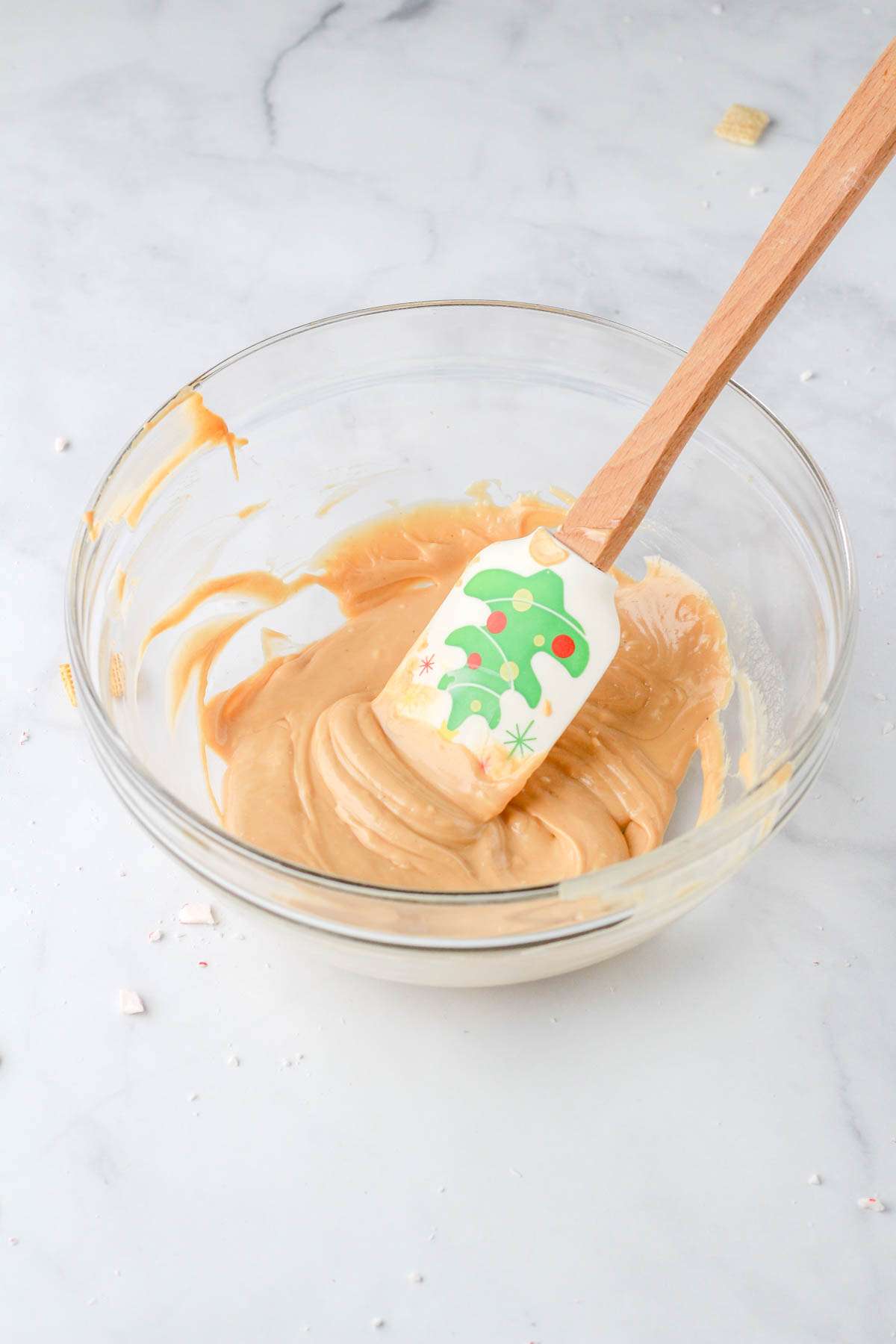 A glass mixing bowl with the white chocolate mixture after heating.