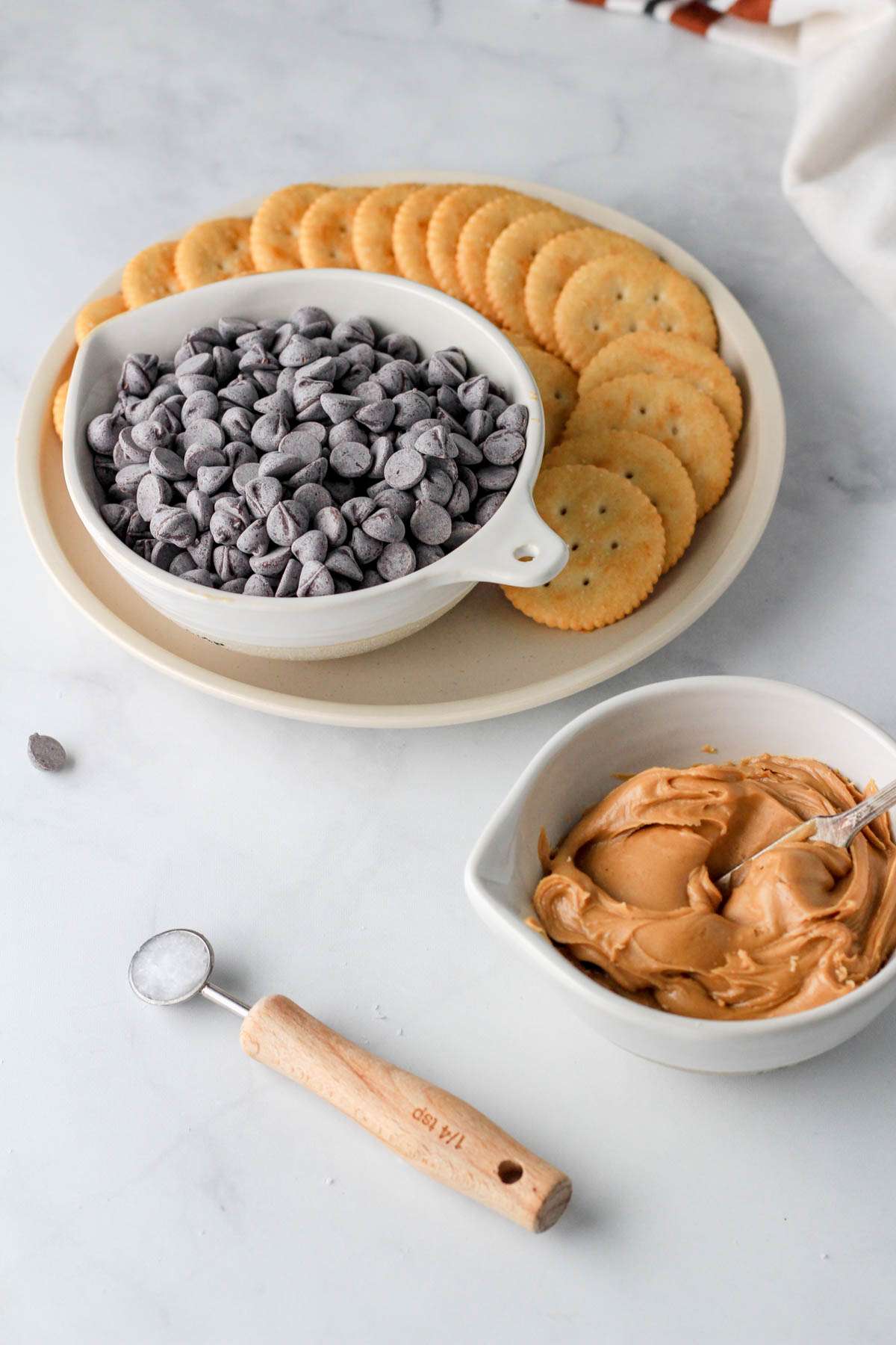 Ingredients for vegan chocolate peanut butter ritz cookies on a white counter.