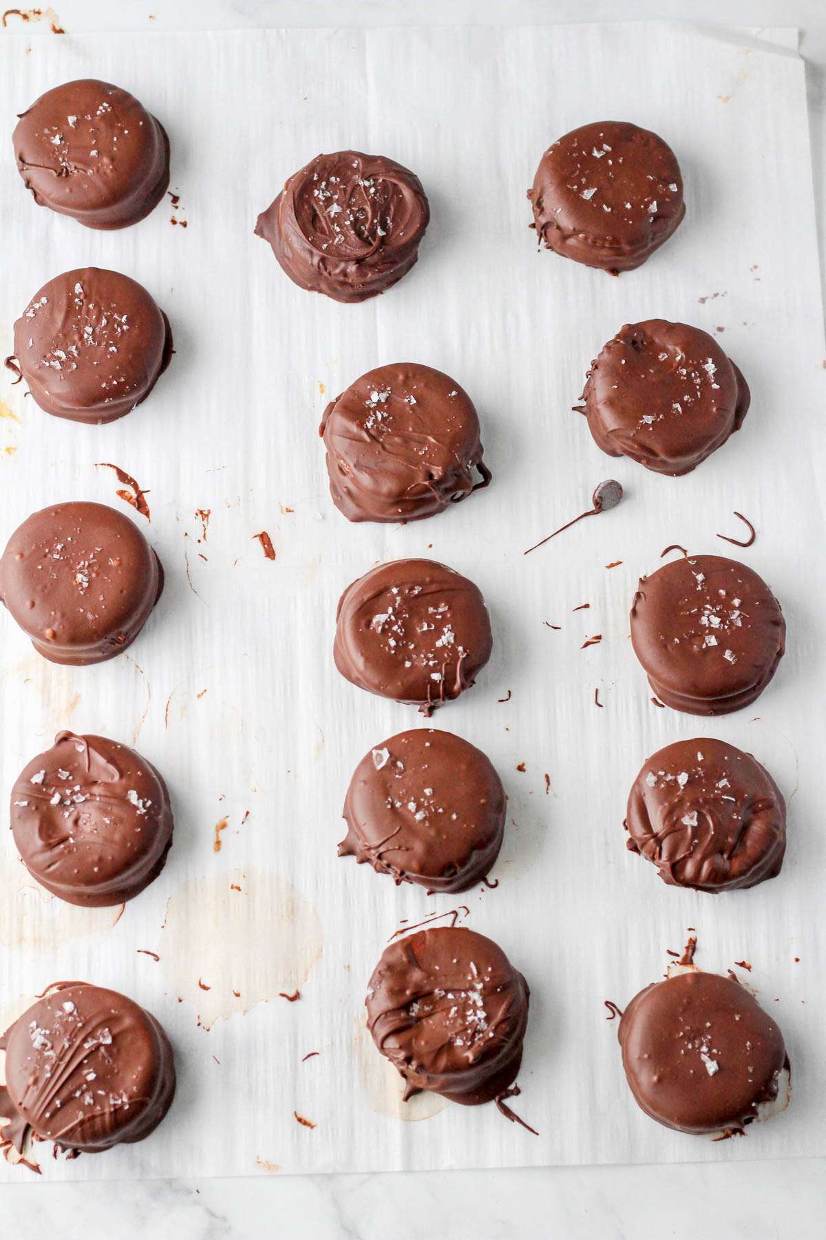 Rows of vegan chocolate peanut butter Ritz cookies after being dipped in chocolate.