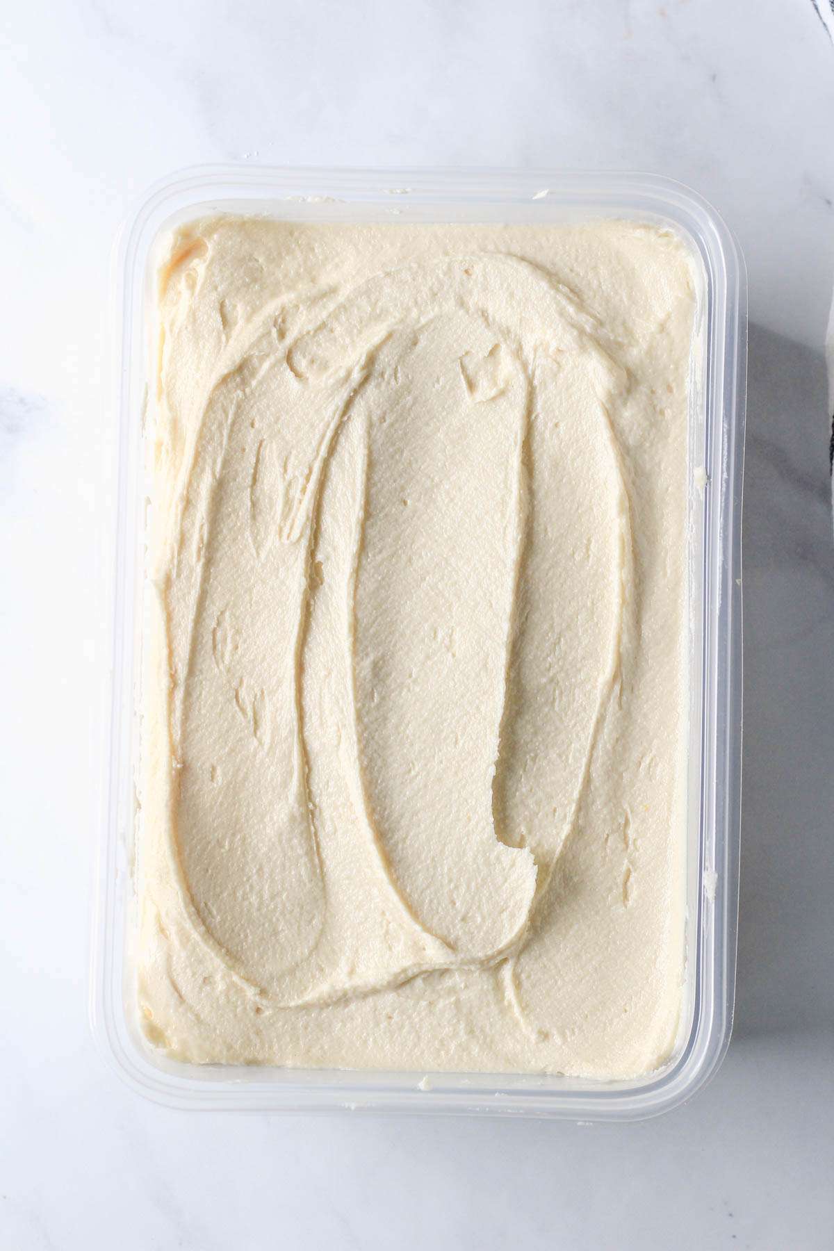 A freezer safe container filled with sugar cookie dough after freezing.