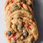 A row of peppermint chocolate chip cookies on a white counter.