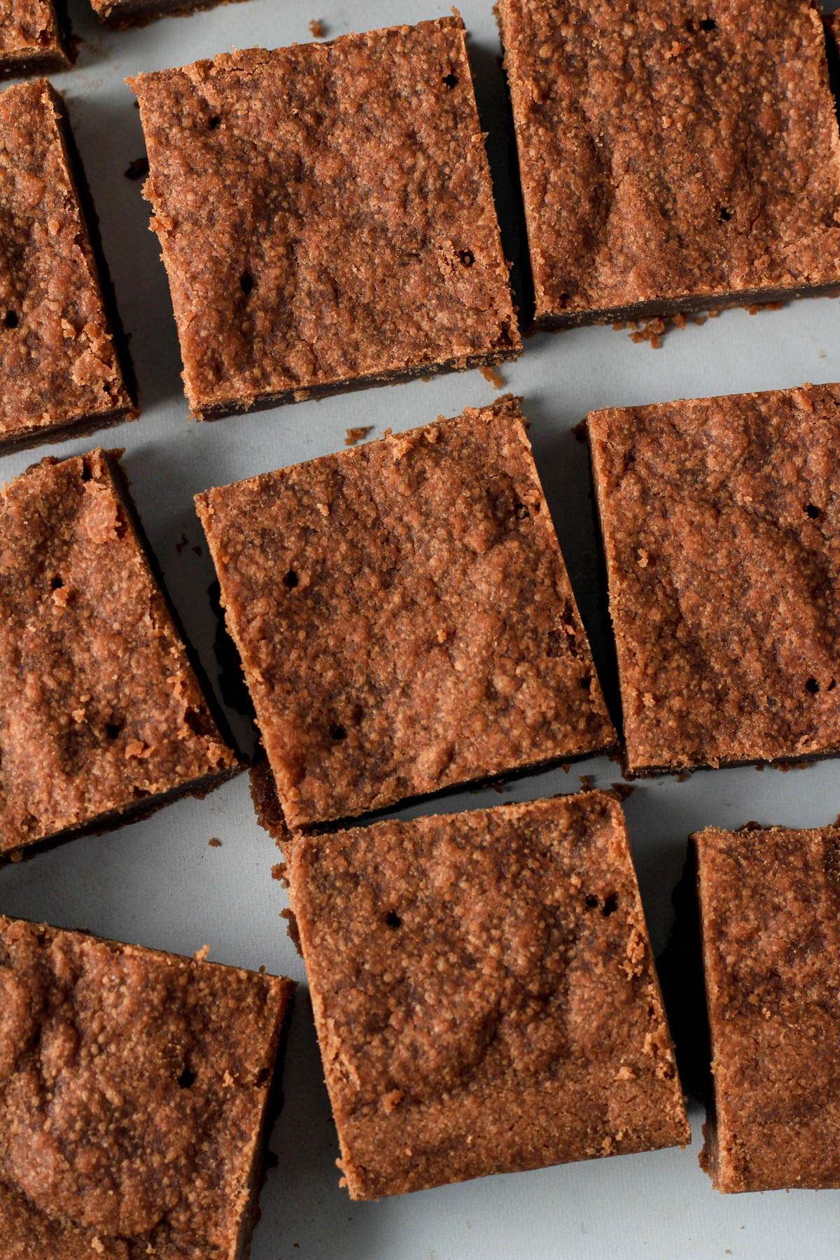 A close up of chocolate vegan shortbread cookies on a white counter.