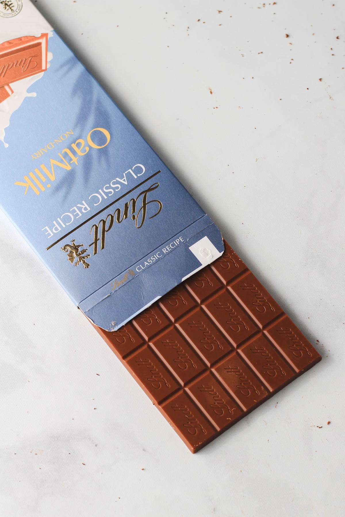 An open box with a dairy-free chocolate bar for Valentine's Day on a white counter.