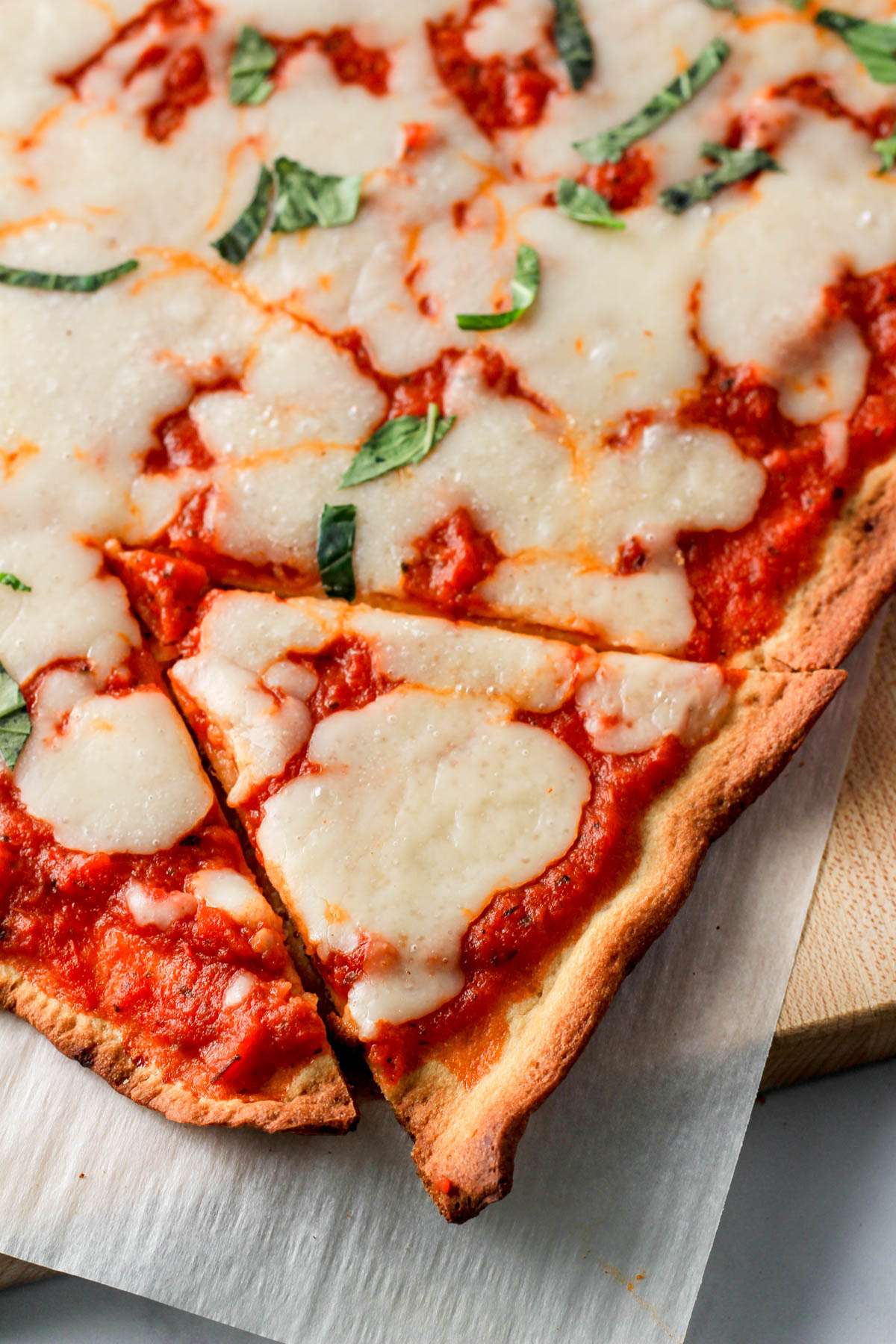 A slice of pizza topped with Miyoko's pourable mozzarella.