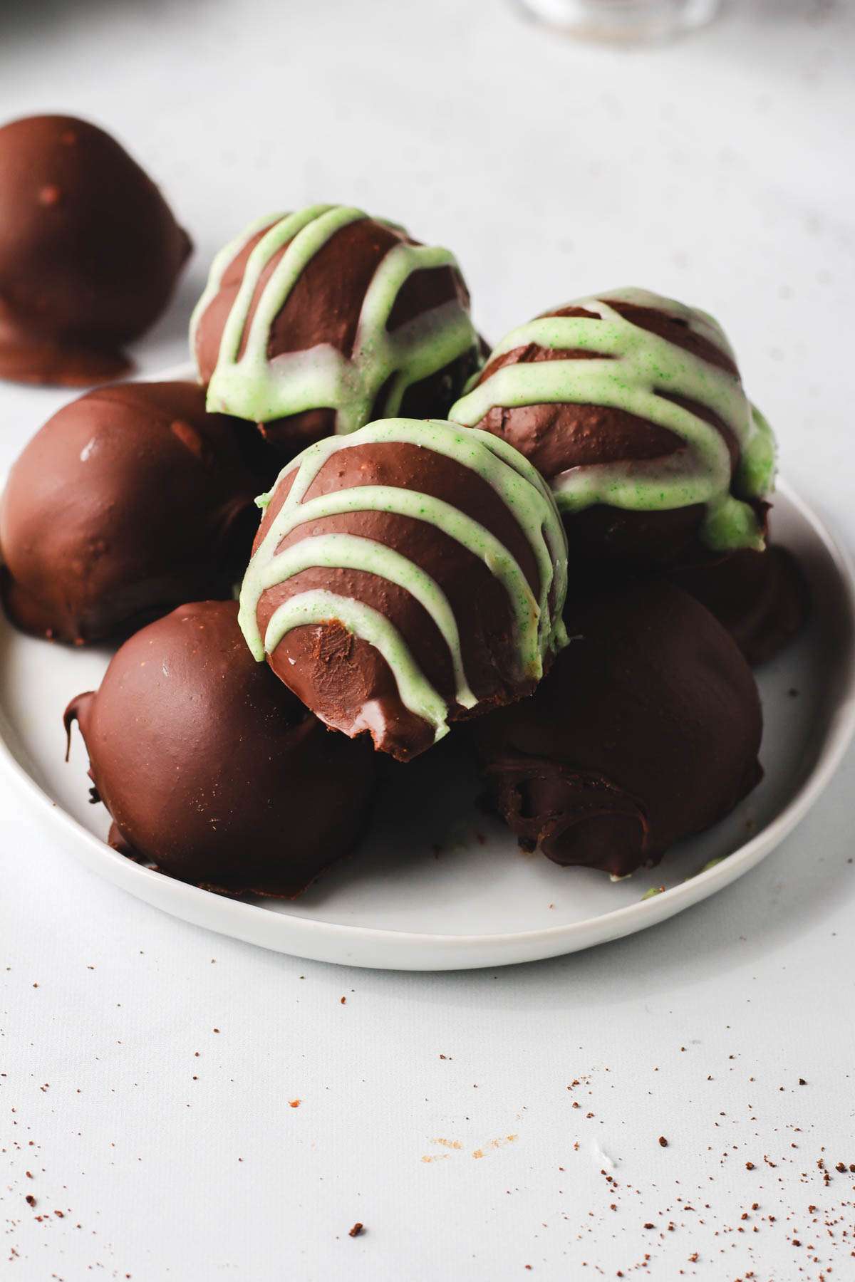 A small white plate with Irish cream Oreo truffles piled on top.