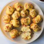 A close up of a cream plate topped with dairy-free egg bites made in the air fryer.