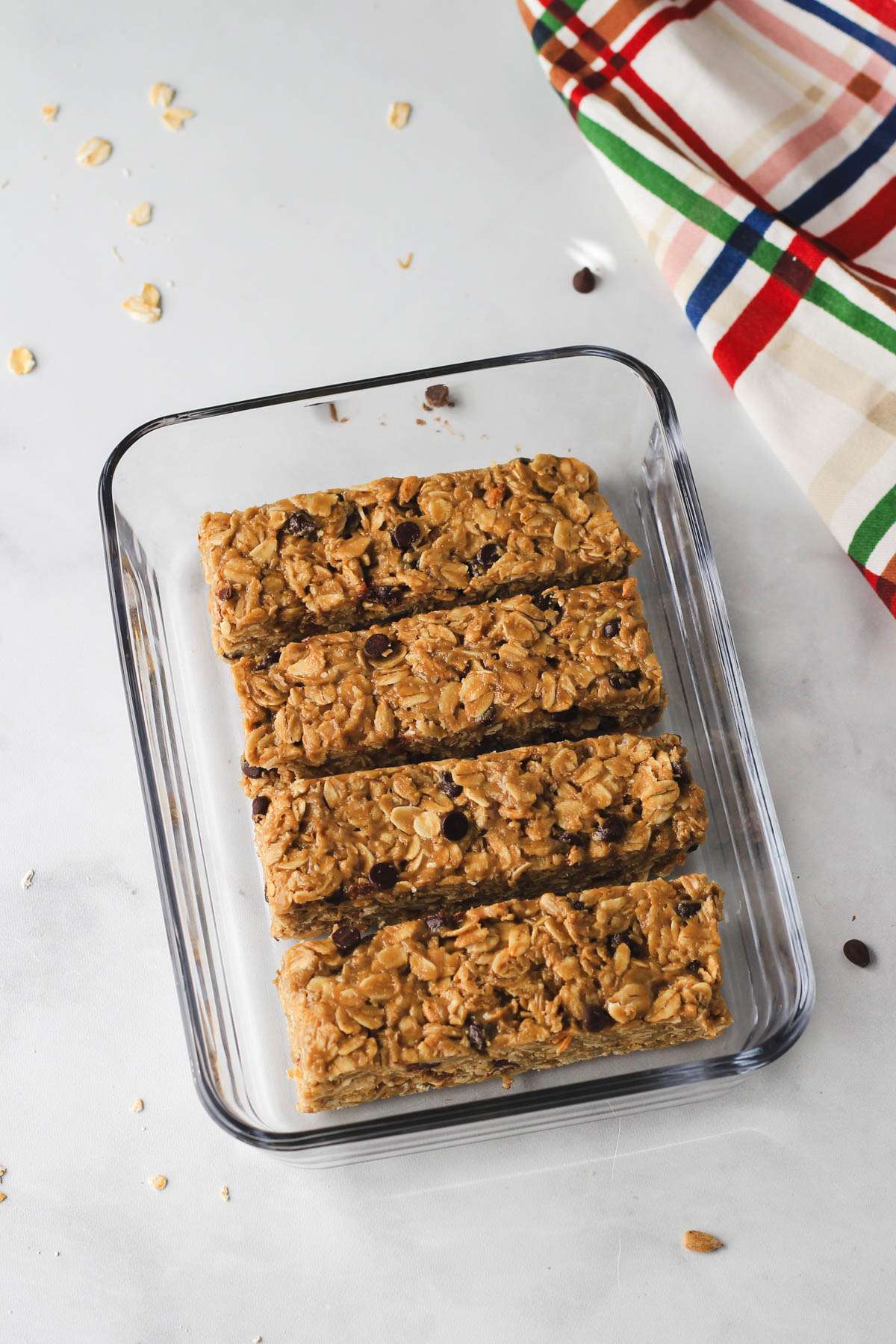 A small glass container with four dairy-free and nut free granola bars.