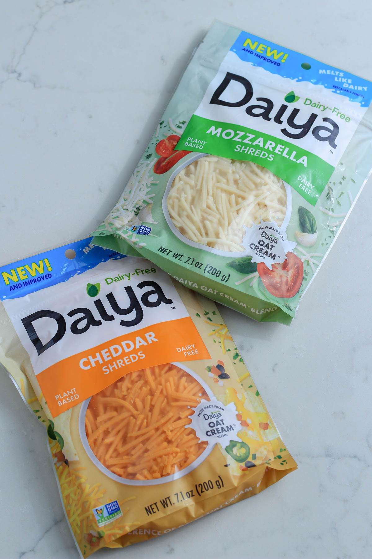 Two packages of Daiya cheese for a review of the product on the counter.