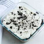 Dairy-free Oreo ice box cake in a glass 8x8 inch baking dish.