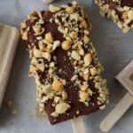 A chocolate dipped, peanut covered, peanut butter banana popsicle.