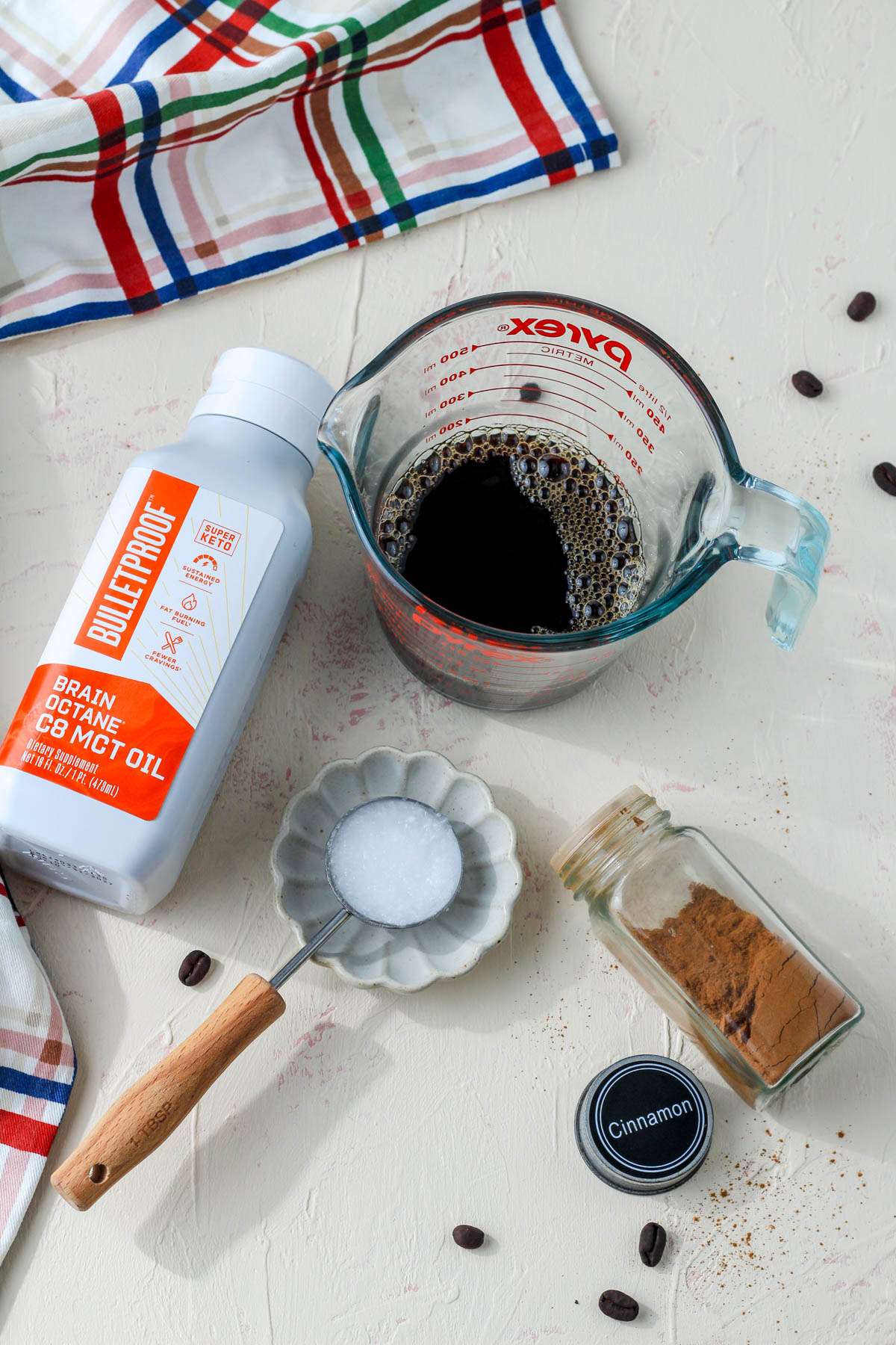 Ingredients for vegan bulletproof coffee on a cream counter.