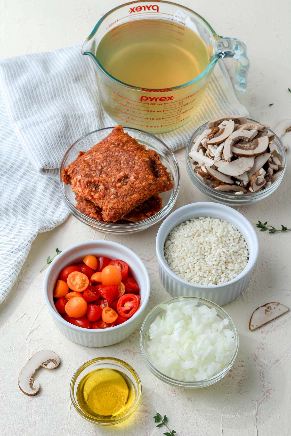 Ingredients for chorizo and mushroom risotto on a cream counter.