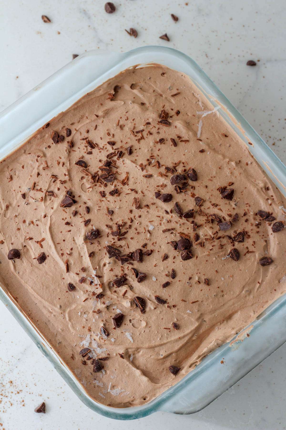 A glass dish with frozen no churn chocolate chocolate chip ice cream.