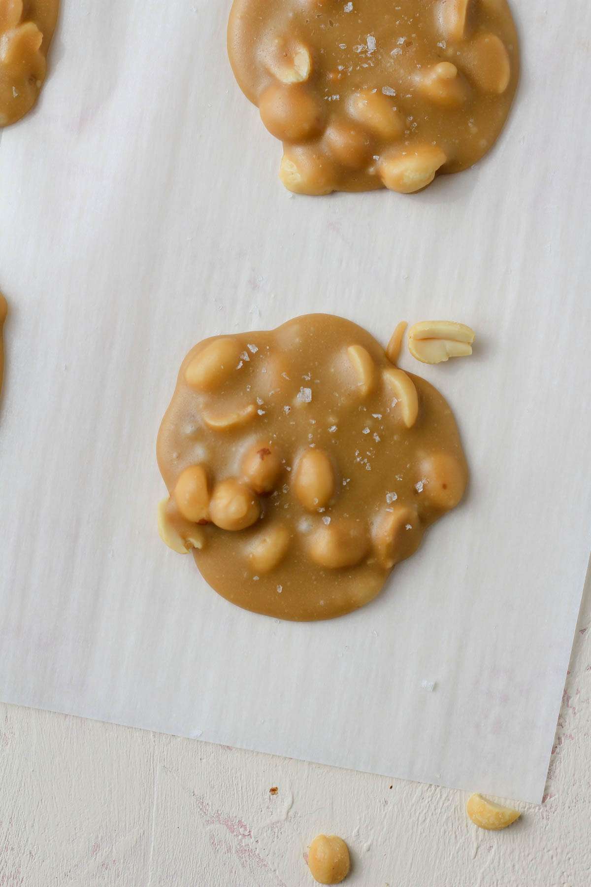 A close up of a vegan peanut praline on a parchment paper.