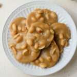 A top down picture of vegan peanut pralines on a white plate.