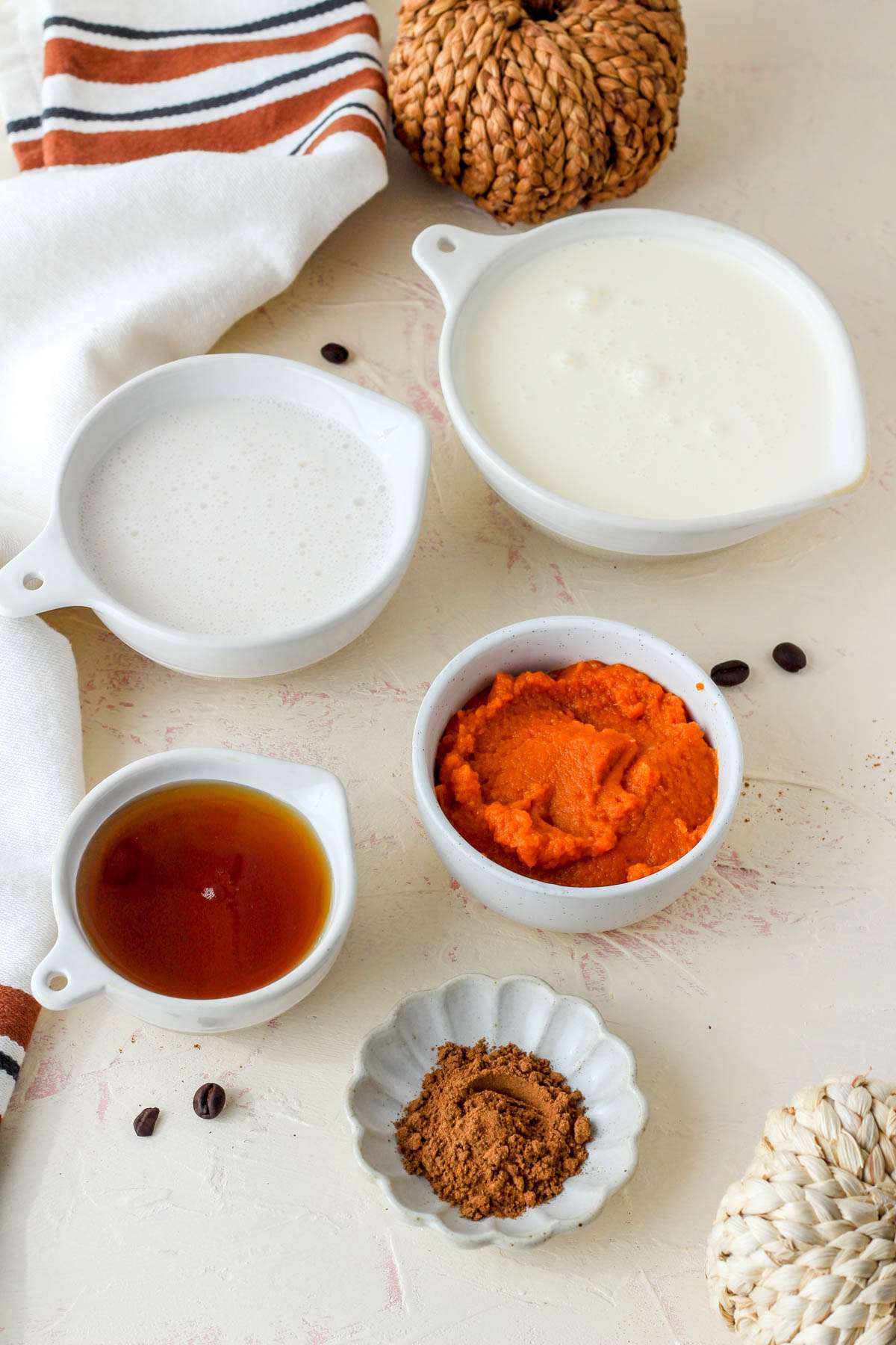 ingredients for pumpkin spice cold foam on a cream counter.