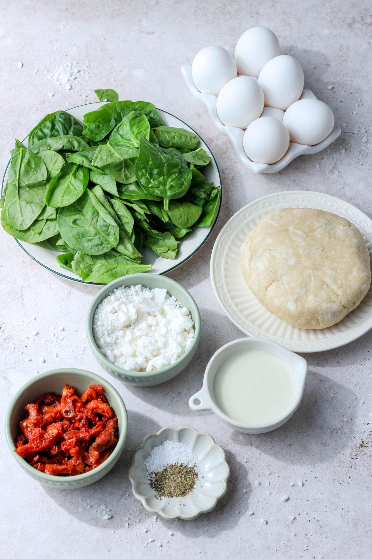 Ingredients for spinach, feta, and sun dried tomato quiche.