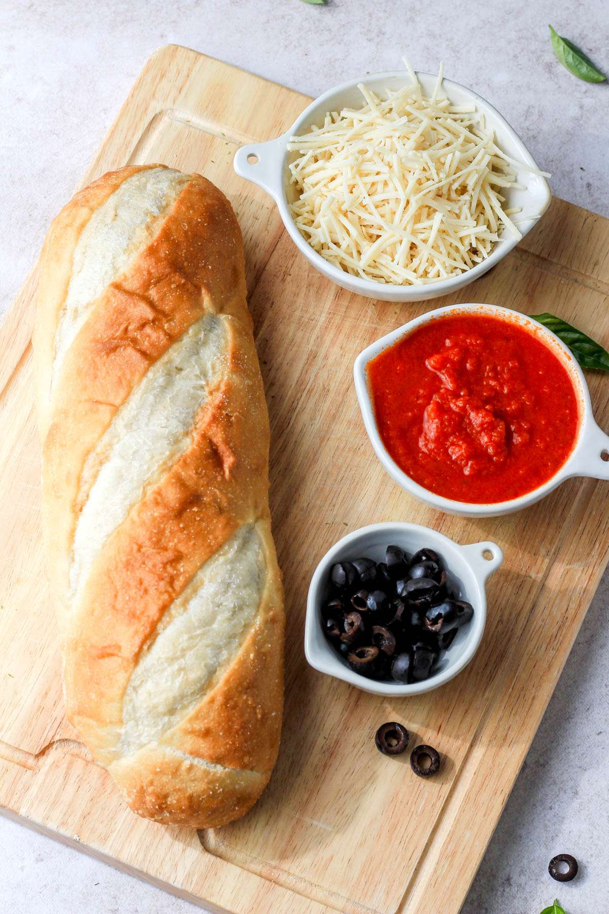 Ingredients for vegan french bread mummy pizzas.