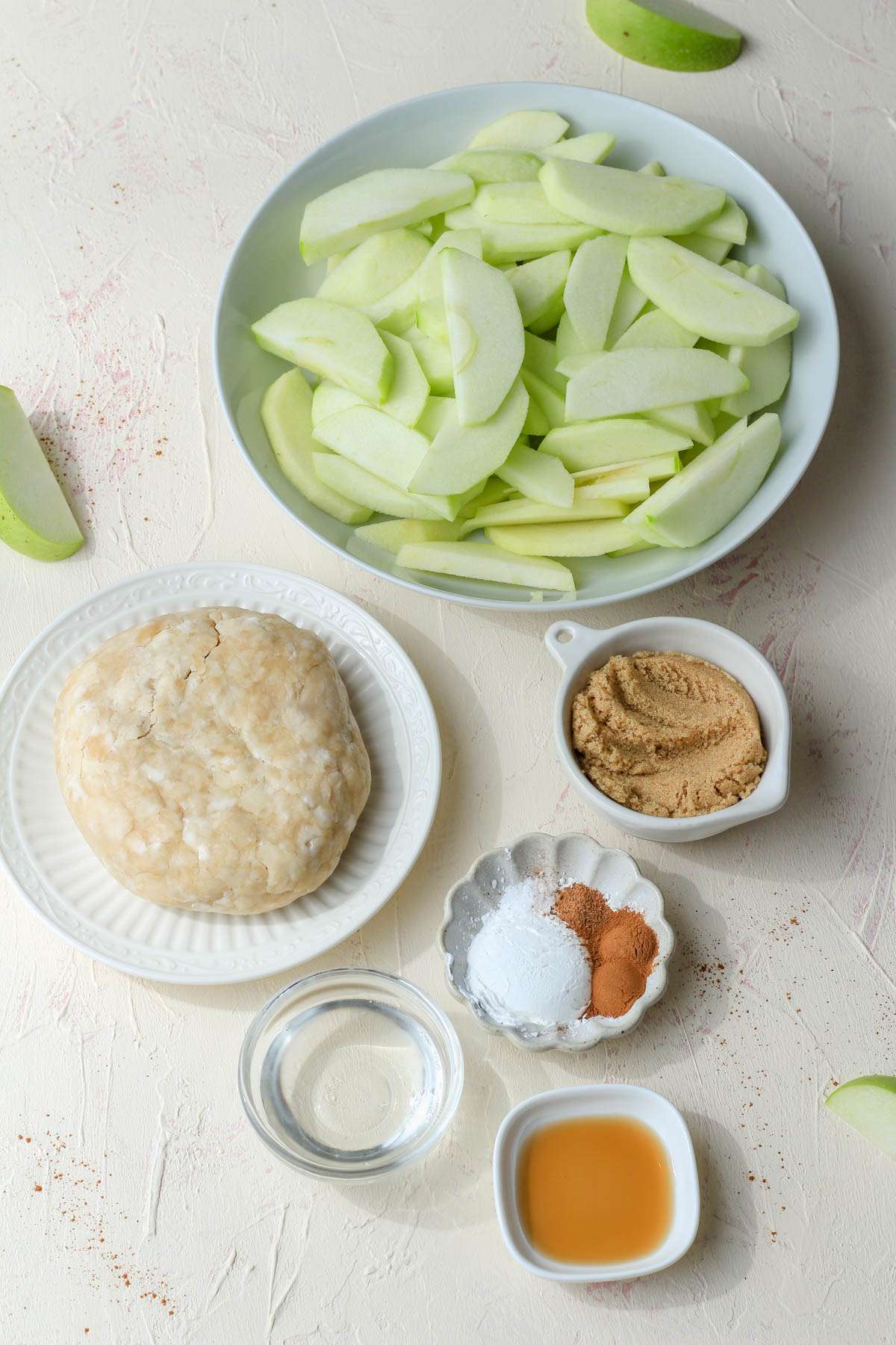 Ingredients for a dairy-free apple galette on a cream counter.