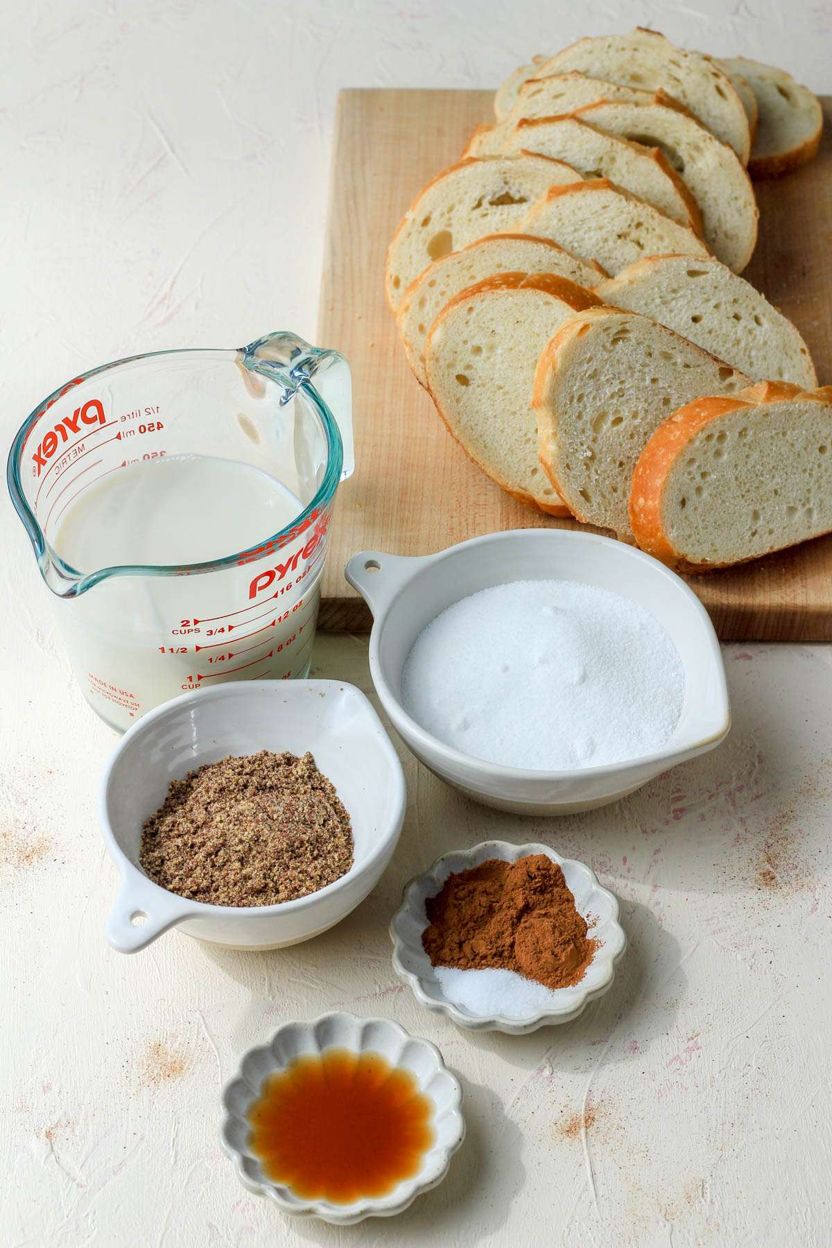 Ingredients for vegan french toast bake on a cream counter.