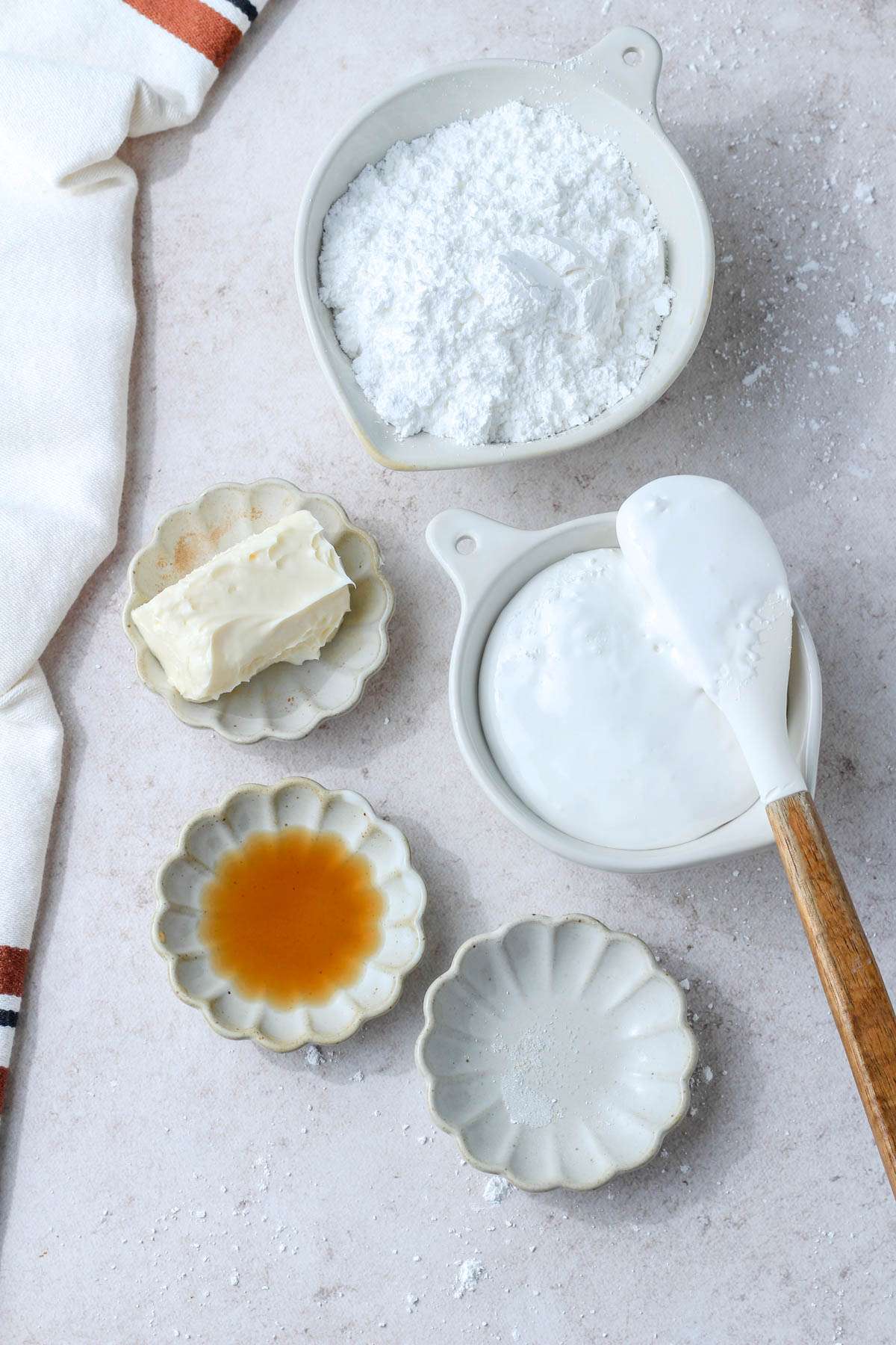 A tan counter with the ingredients to make marshmallow cream icing.