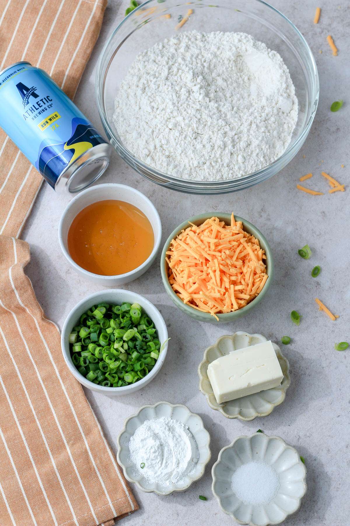 Ingredients for beer bread on a tan counter.