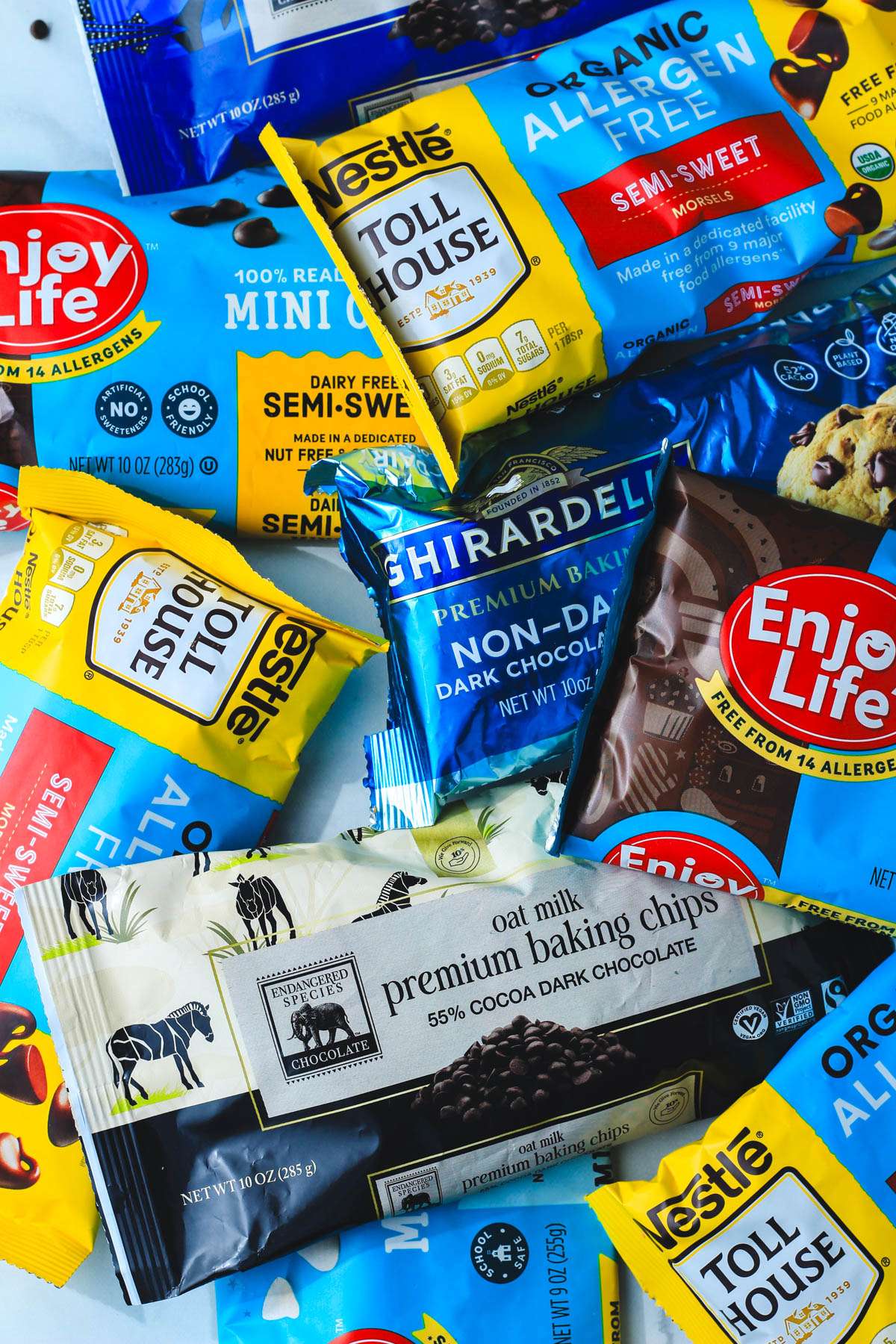A top down image of dairy-free chocolate chip bags piled on a counter.