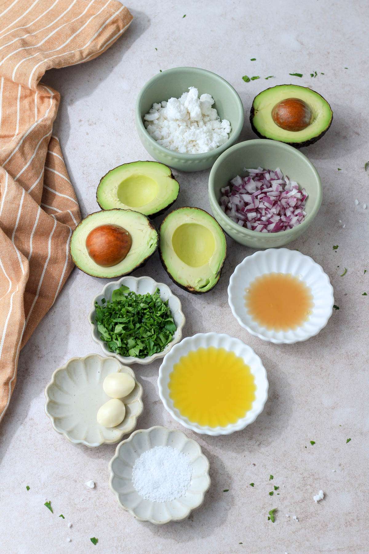 Ingredients for vegan feta avocado dip on a tan counter.