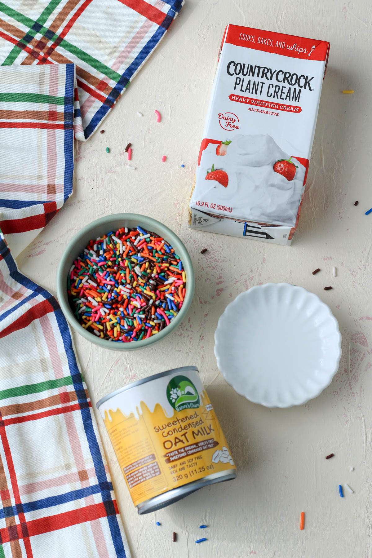 Ingredients for cake batter no churn ice cream on a cream counter.