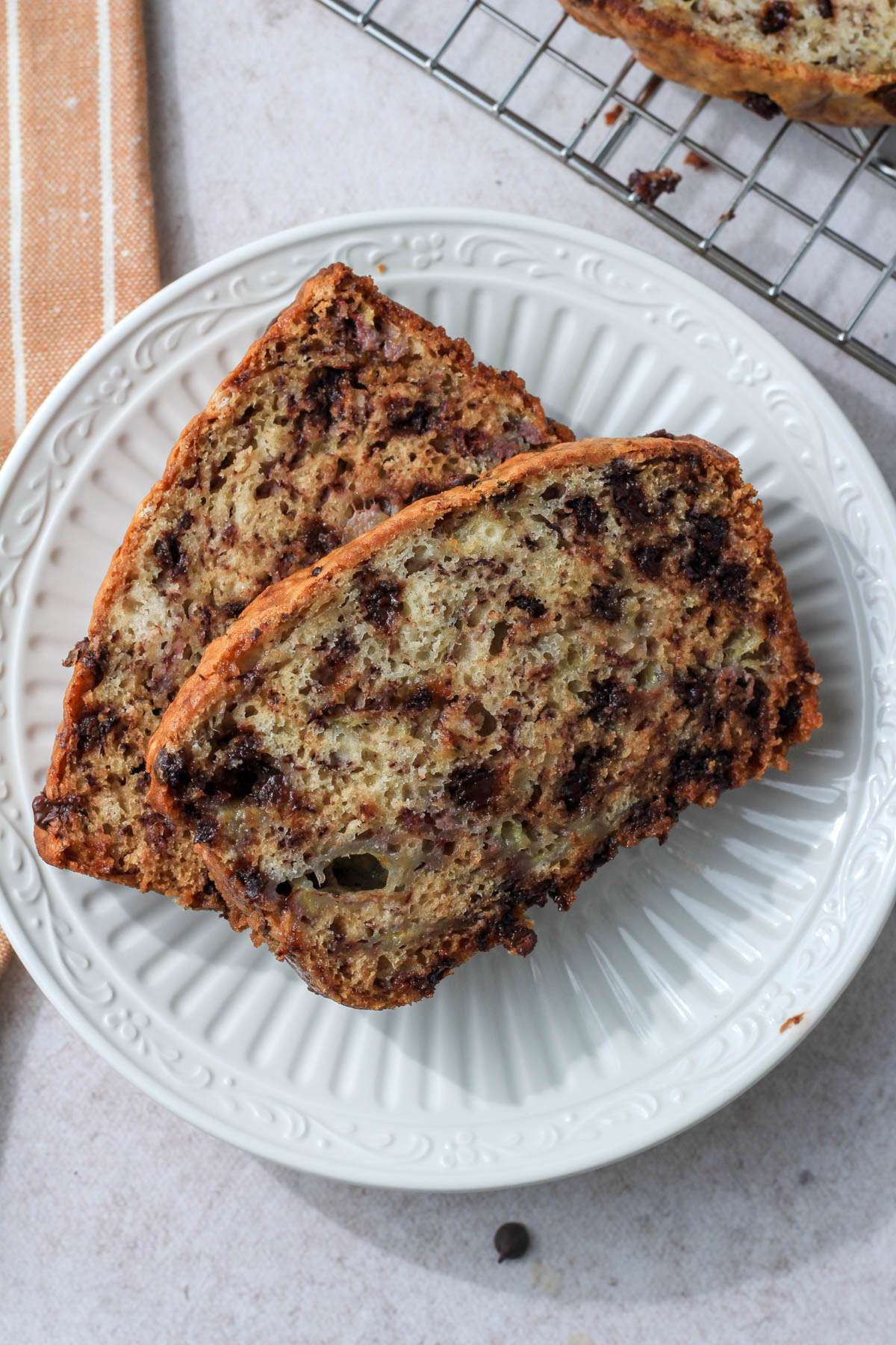 A white plate with two slices of vegan no oil banana bread.