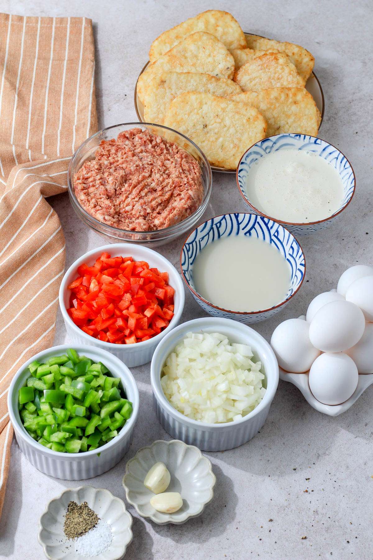 Ingredients for dairy-free hashbrown casserole on a tan counter.