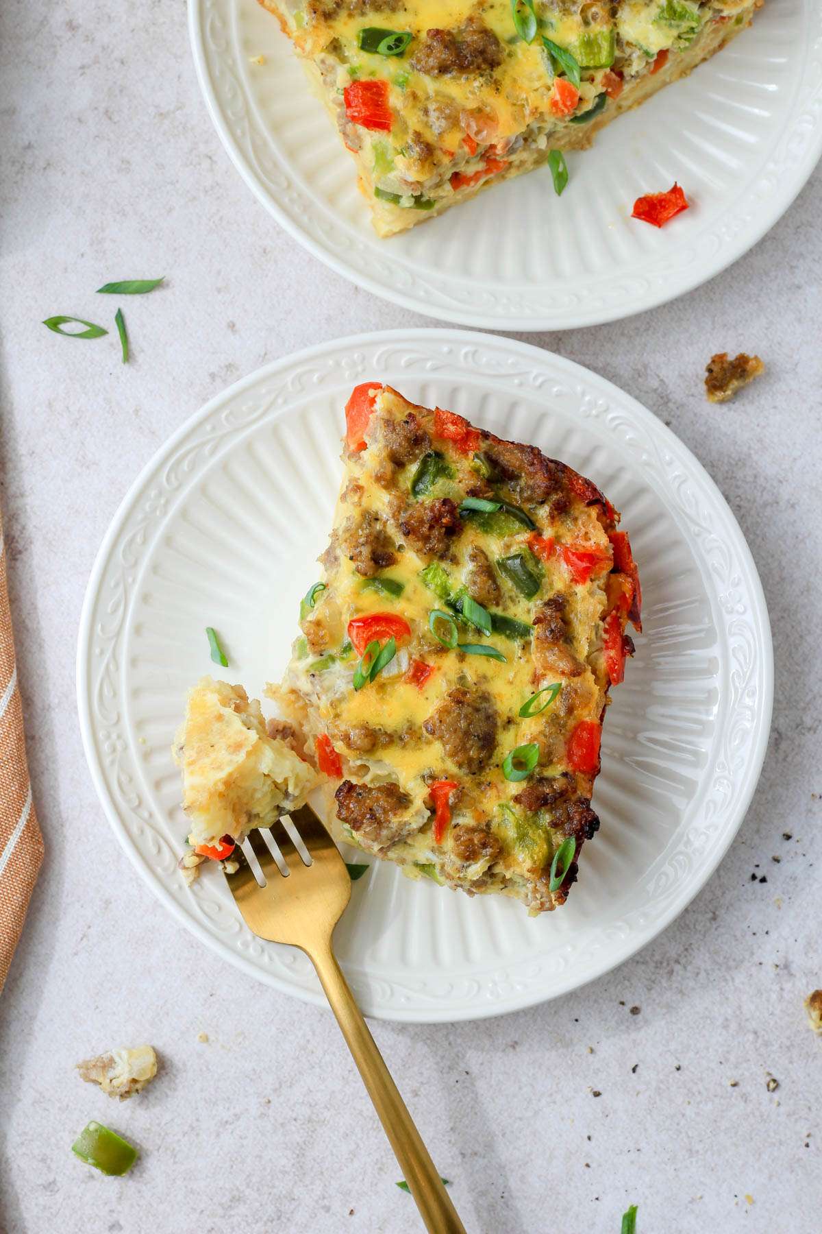 A top down image of two white plates with slices of casserole.