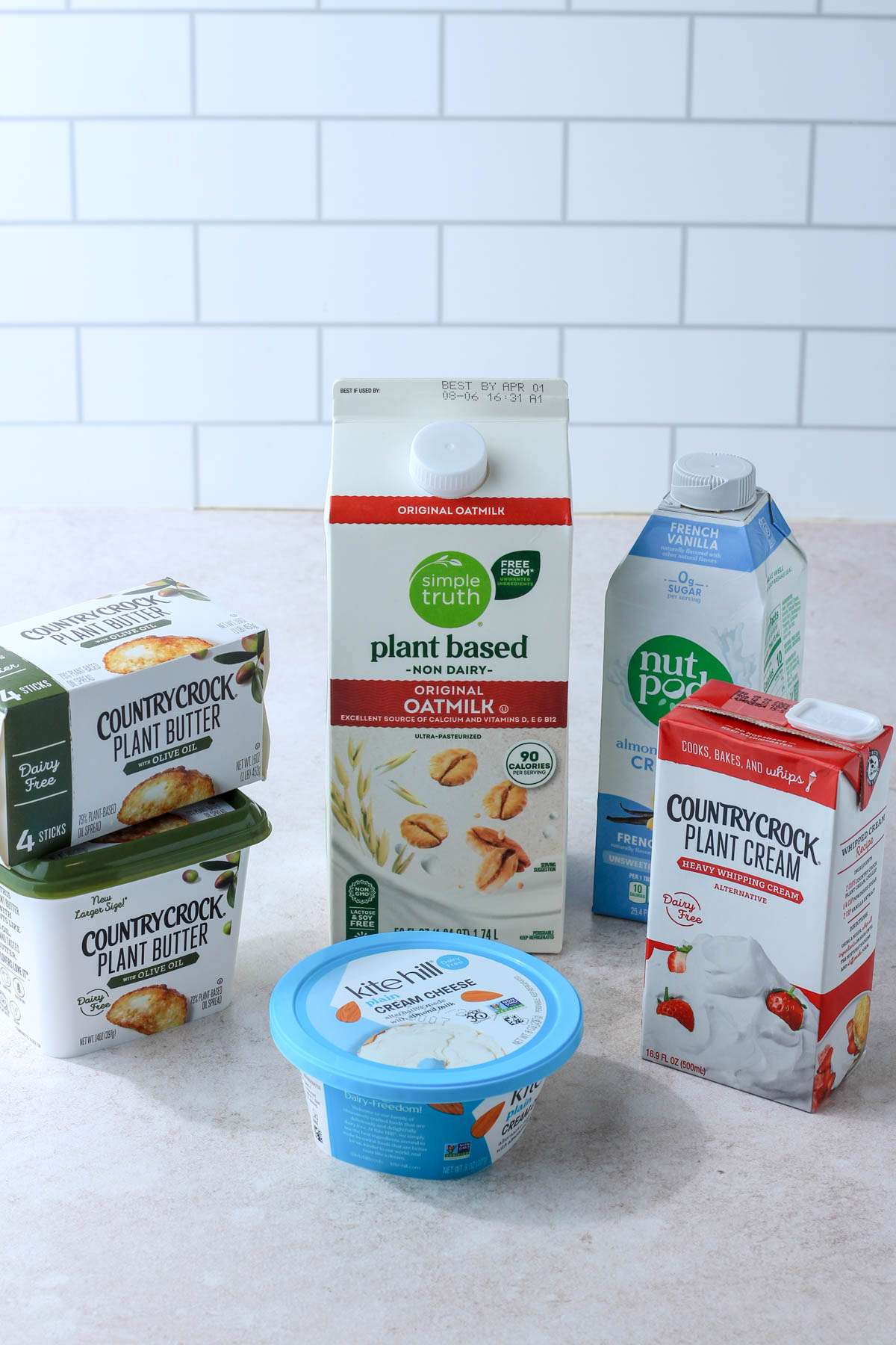 Top 5 products I use in my dairy-free kitchen on a tan counter.