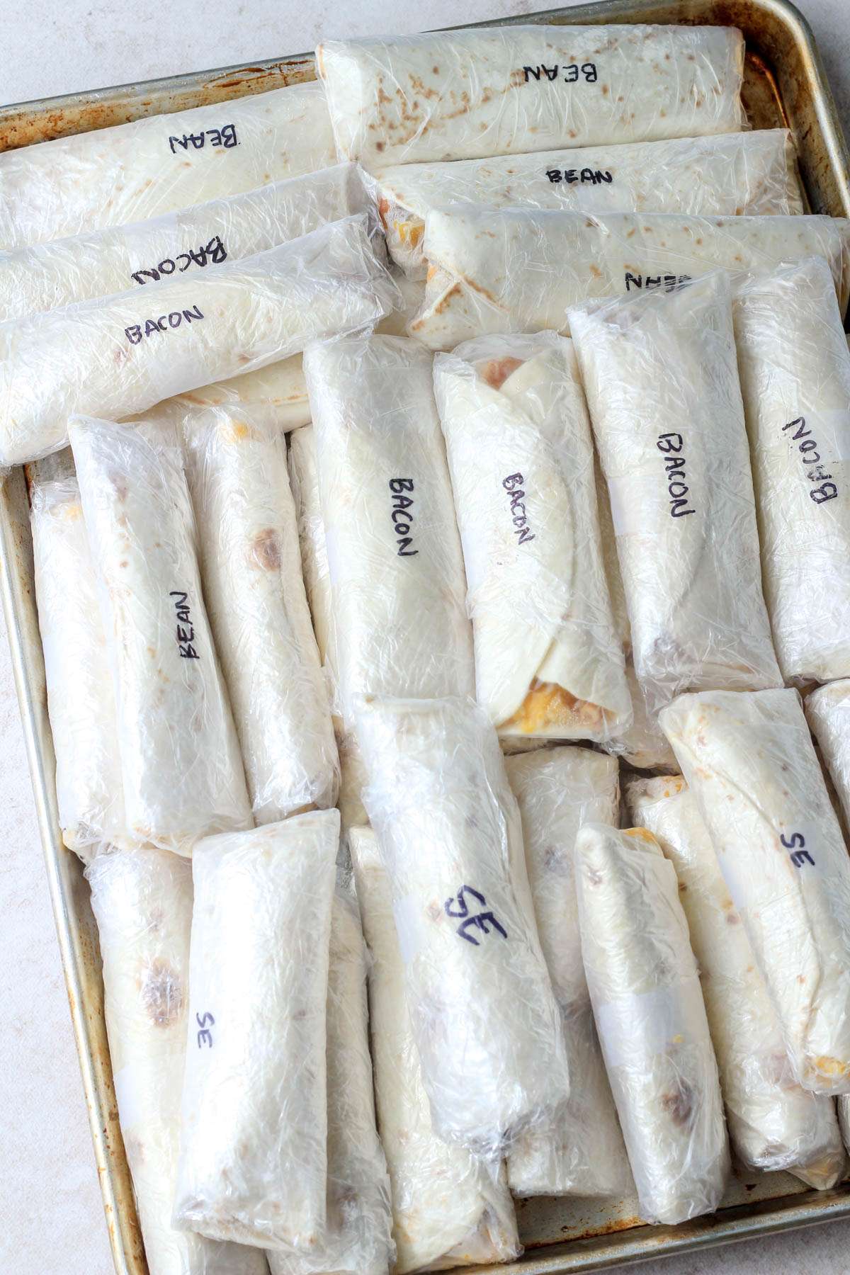 A tray of frozen breakfast burritos for postpartum prep.