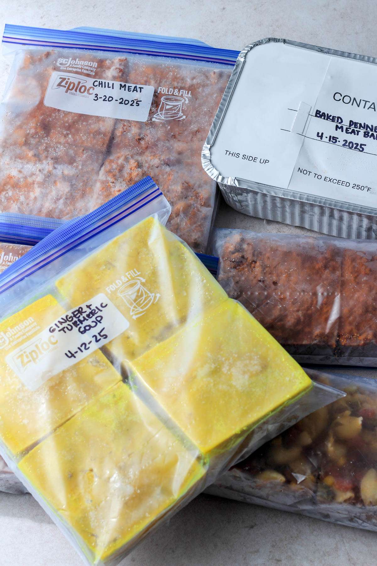 A pile of freezer bags filled with dairy-free meals for postpartum.