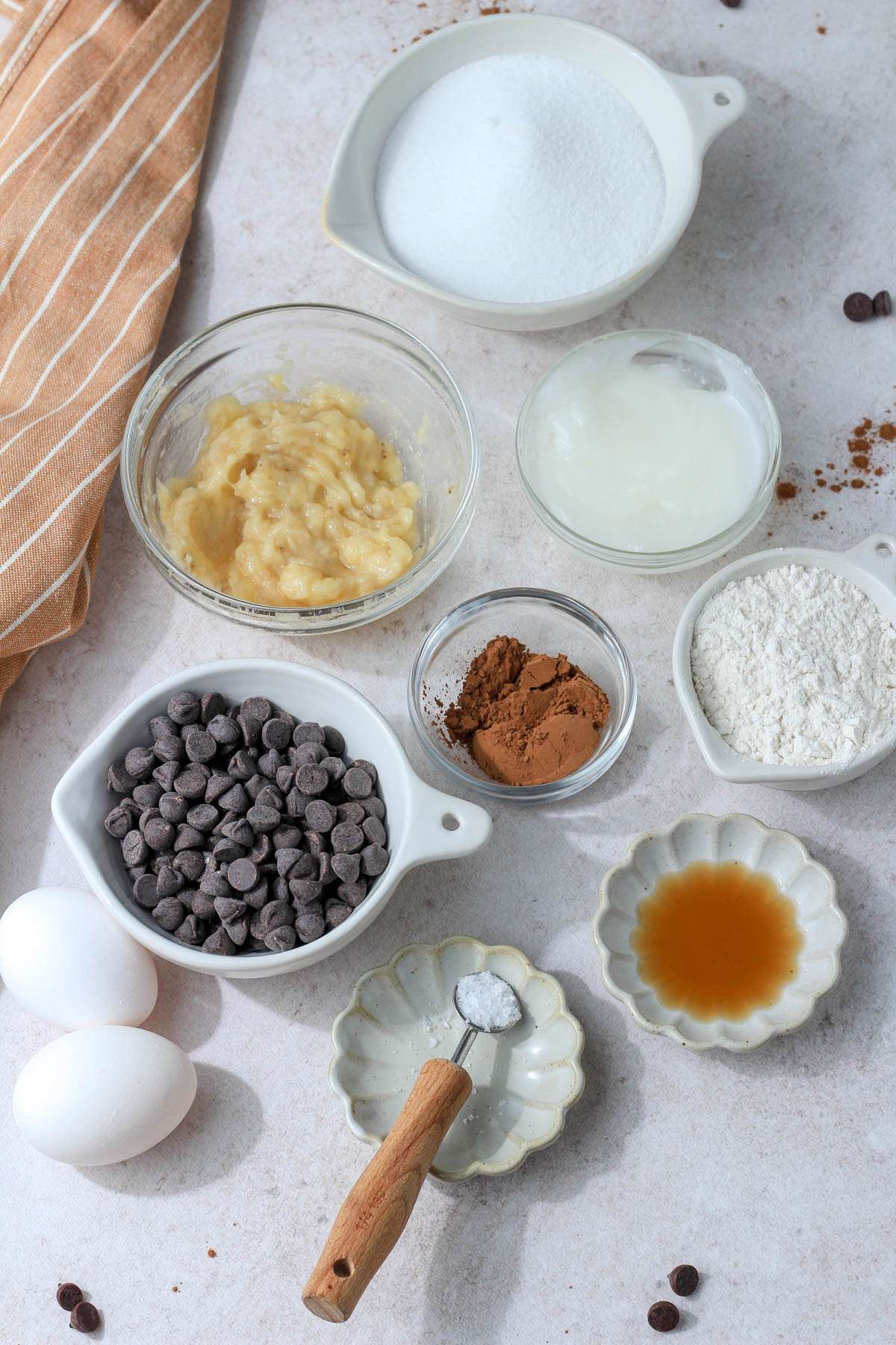 Ingredients for fudgy dairy free brownies on a tan counter.