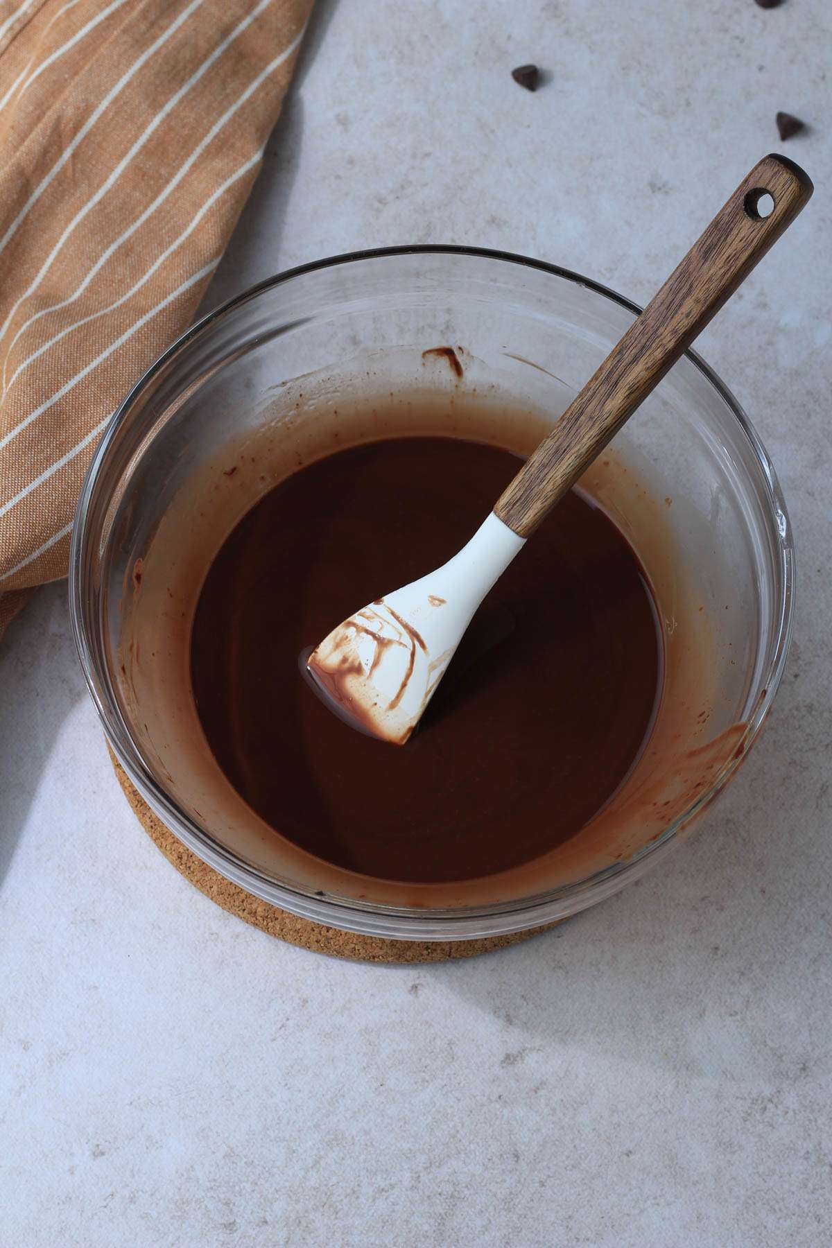 A glass bowl with melted chocolate and coconut oil for the brownie base.