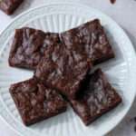 Banana brownies on a white plate.
