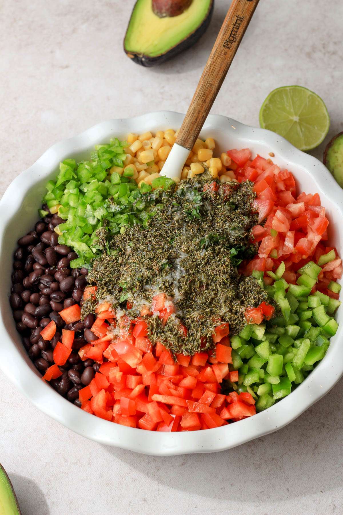 A white dish filled with Texas caviar ingredients before mixing.