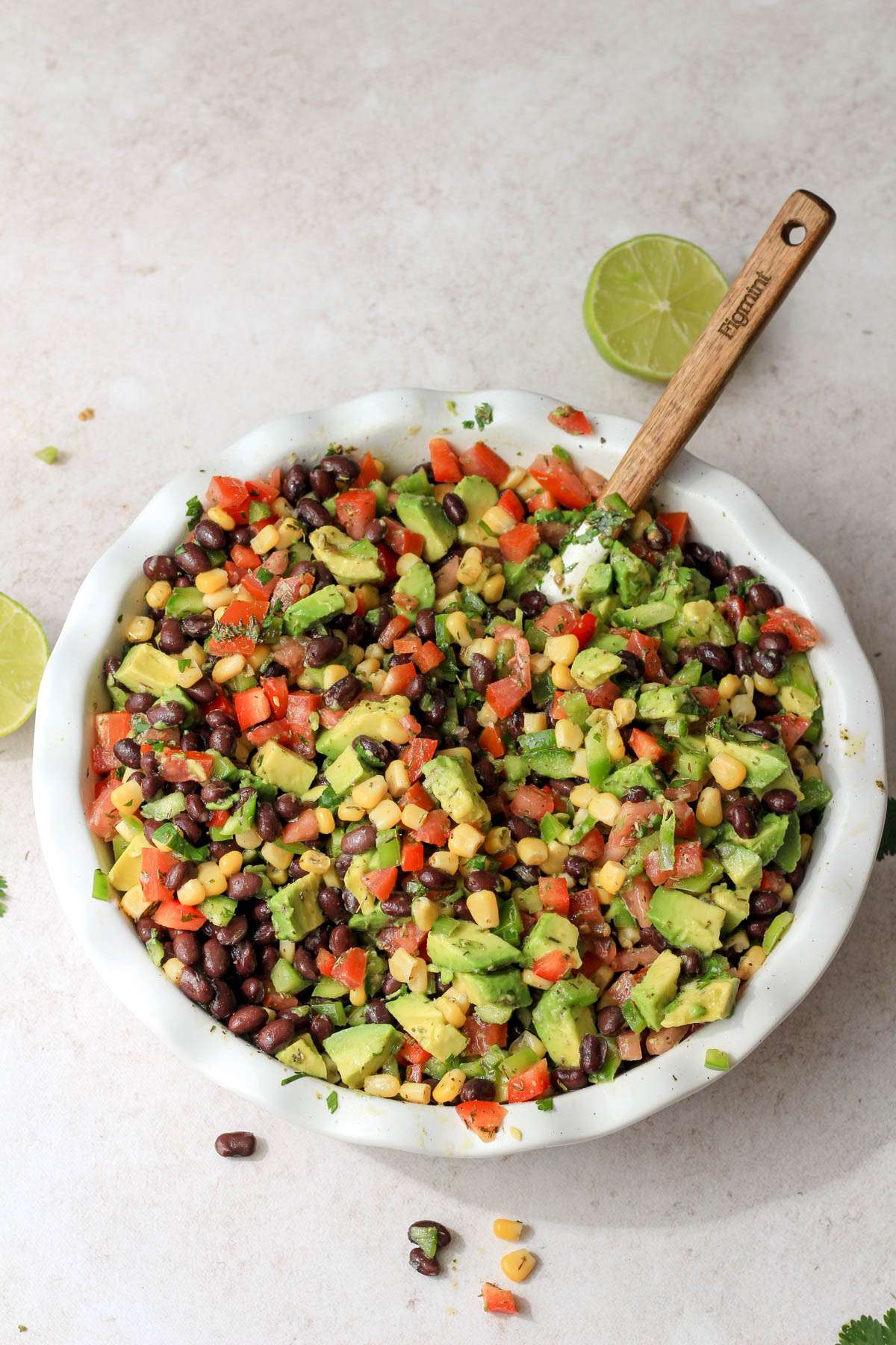A top down of a deep pie dish with Texas caviar after mixing.